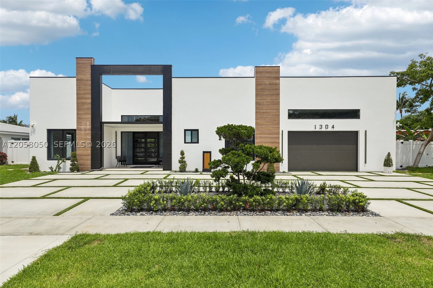 Welcome to SEABREEZE, a newly completed 2026 custom waterfront residence offering modern luxury and ocean access. This single-story home features 3 bedrooms, 3.5 bathrooms, 2,223 SF, soaring 12-foot ceilings, European Padron tile, linear A/C vents, architectural LED lighting, and expansive glass doors framing pool and canal views. The open kitchen showcases Thermador appliances, European-style cabinetry, a waterfall island, and generous storage. The primary suite opens to the pool and features a spa-like bath with dual floating vanities, illuminated mirrors, a freestanding soaking tub, and an oversized dual shower. Outdoors, the entire backyard is finished with low-maintenance turf and designed for year-round entertaining, featuring a resort-style pool with sun shelf and multiple water features, plus an expansive covered patio with hardwood ceiling and oversized fans. The fully equipped outdoor kitchen includes a built-in grill, side burners, refrigerator, sink, and storage. Set on an 8,028 SF lot with 50 feet of waterfront, seawall, private dock, and one fixed bridge. Additional features include a private-entrance flex suite, laundry room, mudroom, walk-in primary closet, one-car garage, circular driveway, and golf-cart parking.