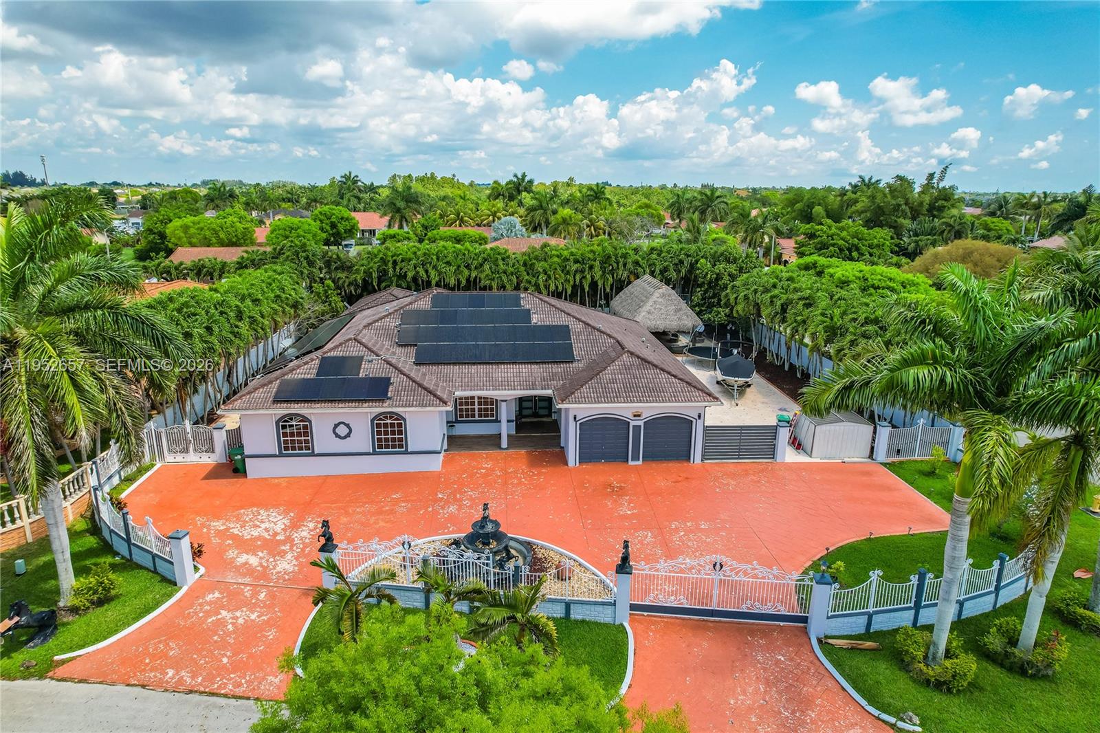 Here's an amazing opportunity to buy this stunning estate luxury home! It boasts 5 bedrooms, 4 bathrooms, and sits on a spacious 21,000 sq ft lot with an actual living area of 4,688 sq ft. There's a guest house with a pool and a large, heated pool as well, with two new a/c units.  The outdoor space is perfect for entertaining friends and family, featuring a chef's kitchen, a heated pool with a spa, paved flooring, a tiki hut, and even room for your boat. Plus, the home is equipped with electric panels for significant electricity savings. It's easy to show and ready for you to move in!