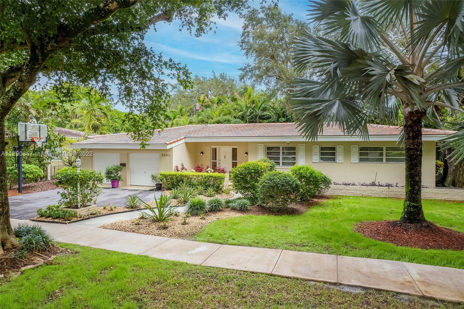 Spacious 4 bedroom, 2 bathroom home located on a quiet street in sought-after South Coral Gables. Real wood floors, rustic tiles, and a large Florida room overlooking a beautifully landscaped backyard with lush vegetation give this home a classic and elegant atmosphere. Both bathrooms have been updated.  A two-car garage (rare in the neighborhood) with a driveway allows for ample parking.  The Florida Room features coffered ceilings and window walls. Surrounded by multi-million dollar properties, this home sits on a 10,000 sf lot in a tree-lined street with little traffic, 2 blocks away from US-1, minutes from Coconut Grove, the University of Miami, the Riviera Country Club, Merrick Park, and world-class restaurants and shops.  Open House on Sunday 10/30/22 from 12pm to 3pm. Must see!