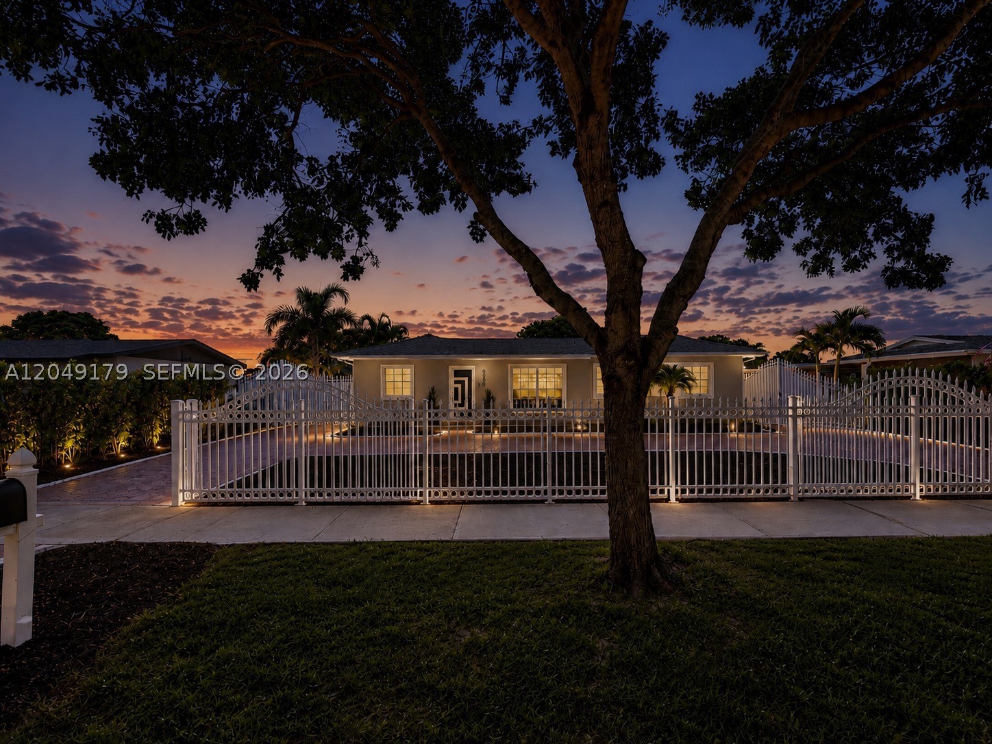 NO HOA! Bring your boat, RV, work vehicles, and all your toys! Beautifully updated and move-in ready, this exceptional 5-bedroom, 3-bath home sits on a private 7,875 SF lot featuring a grand motorized gated entrance, decorative white metal fencing, expansive stamped concrete circular driveway with decorative aprons, generous side-yard parking, and a spacious backyard with room for a future pool. Major improvements include a permitted architectural shingle roof (2023), permitted bronze privacy fence (2025), impact-rated front door, hurricane shutters, Rheem A/C (2019), EcoSmart tankless water heater, two mini-split A/C systems, Google Nest thermostat, updated soffits/fascia, and an insulated aluminum covered patio with rain gutters. The updated kitchen features quartz countertops, an oversized island, Samsung stainless steel appliances, LED pendant lighting, abundant cabinetry, and an open layout ideal for entertaining. Interior finishes include Modern Urban Ash luxury vinyl plank flooring, smooth knockdown walls and ceilings, 5-inch crown molding/baseboards, designer zebra shades, and updated lighting. Enjoy professionally landscaped grounds with mature Foxtail palms, a lush Podocarpus privacy hedge, Govee smart exterior lighting, owned ADT security system, Tapo cameras, detached utility/storage building, and exceptional indoor/outdoor living.