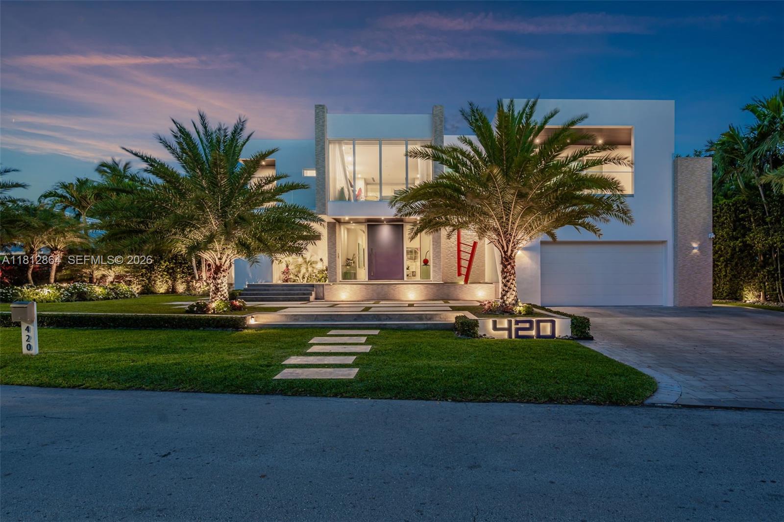 Spectacular and impeccably appointed modern residence situated on a 13,651 SF lot on prestigious Island Drive—one of Key Biscayne’s most elevated streets. Boasting a total of 8,011 SF, this 6-bedroom, 6 full bath + 2 half bath home is open, bright, and flooded with natural light throughout. Enjoy breathtaking water views and private access to the water in a setting that blends refined luxury with ultimate privacy. This residence showcases exquisitely curated, high-end designer finishes, a dramatic wine cellar, two expansive family rooms, and a closed 2-car garage. The outdoor living area is equally impressive, featuring a sleek summer kitchen and lush, professionally designed landscaping—ideal for elegant island living and entertaining. Per approved plans 6,405 SF under AC -8,682 SF Total