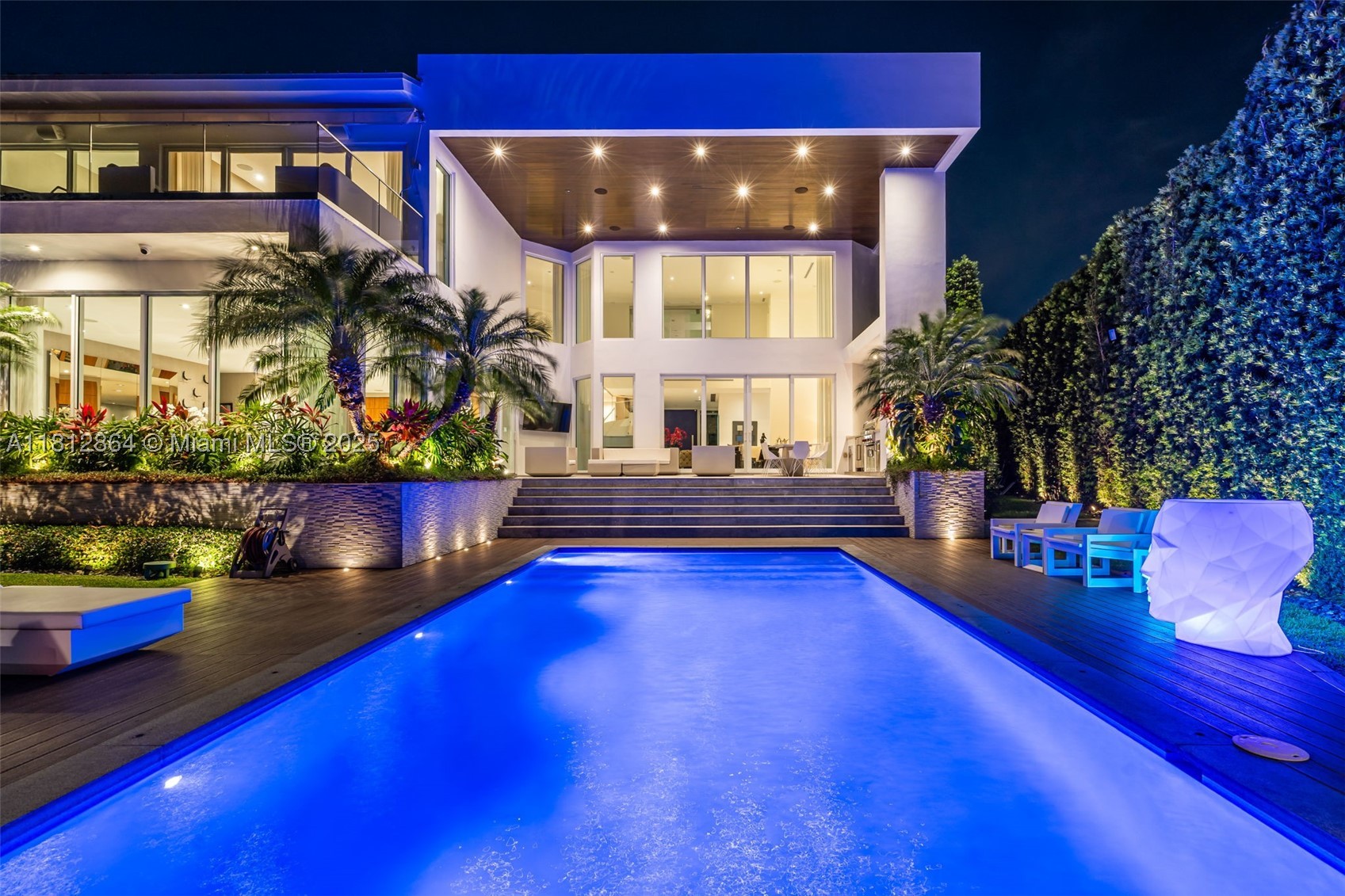 Spectacular and impeccably appointed modern residence situated on a 13,651 SF lot on prestigious Island Drive—one of Key Biscayne’s most elevated streets. Boasting a total of 8,011 SF, this 6-bedroom, 6 full bath + 2 half bath home is open, bright, and flooded with natural light throughout. Enjoy breathtaking water views and private access to the water in a setting that blends refined luxury with ultimate privacy. This residence showcases exquisitely curated, high-end designer finishes, a dramatic wine cellar, two expansive family rooms, and a closed 2-car garage. The outdoor living area is equally impressive, featuring a sleek summer kitchen and lush, professionally designed landscaping—ideal for elegant island living and entertaining. Per approved plans 6,405 SF under AC -8,682 SF Total