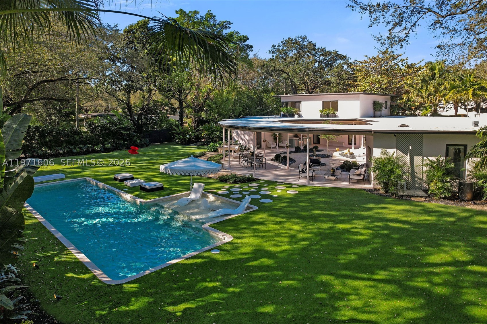 Recently featured in WSJ’s Mansion Global, Panorama House is a rare mid-century architectural estate set on nearly half an acre in the heart of Miami Shores.  


Discreet from the street, the home unfolds through a bamboo-lined entry beneath a mature oak canopy before opening to expansive lawns and tropical gardens anchored by a 42’ heated saltwater lap pool. Centered around a tranquil Zen garden, the residence offers a seamless indoor-outdoor living experience. Originally designed in 1950 by architect Joseph DeBrita and fully reimagined by Shoreland Group in 2025, the 5BD/7BA home blends authentic mid-century design with elevated modern finishes. The reconfigured layout includes dual primary suites, spa-style baths with steam, custom millwork, terrazzo and European oak flooring, and a chef’s kitchen with Miele, Fisher & Paykel, and Liebherr appliances.


Additional highlights include a cinema/game lounge, guest apartment wing, and a 1,000 SF covered outdoor pavilion with summer kitchen, all set within lush, private grounds. A rare offering combining scale, privacy, and architectural significance in a prime Miami Shores location.