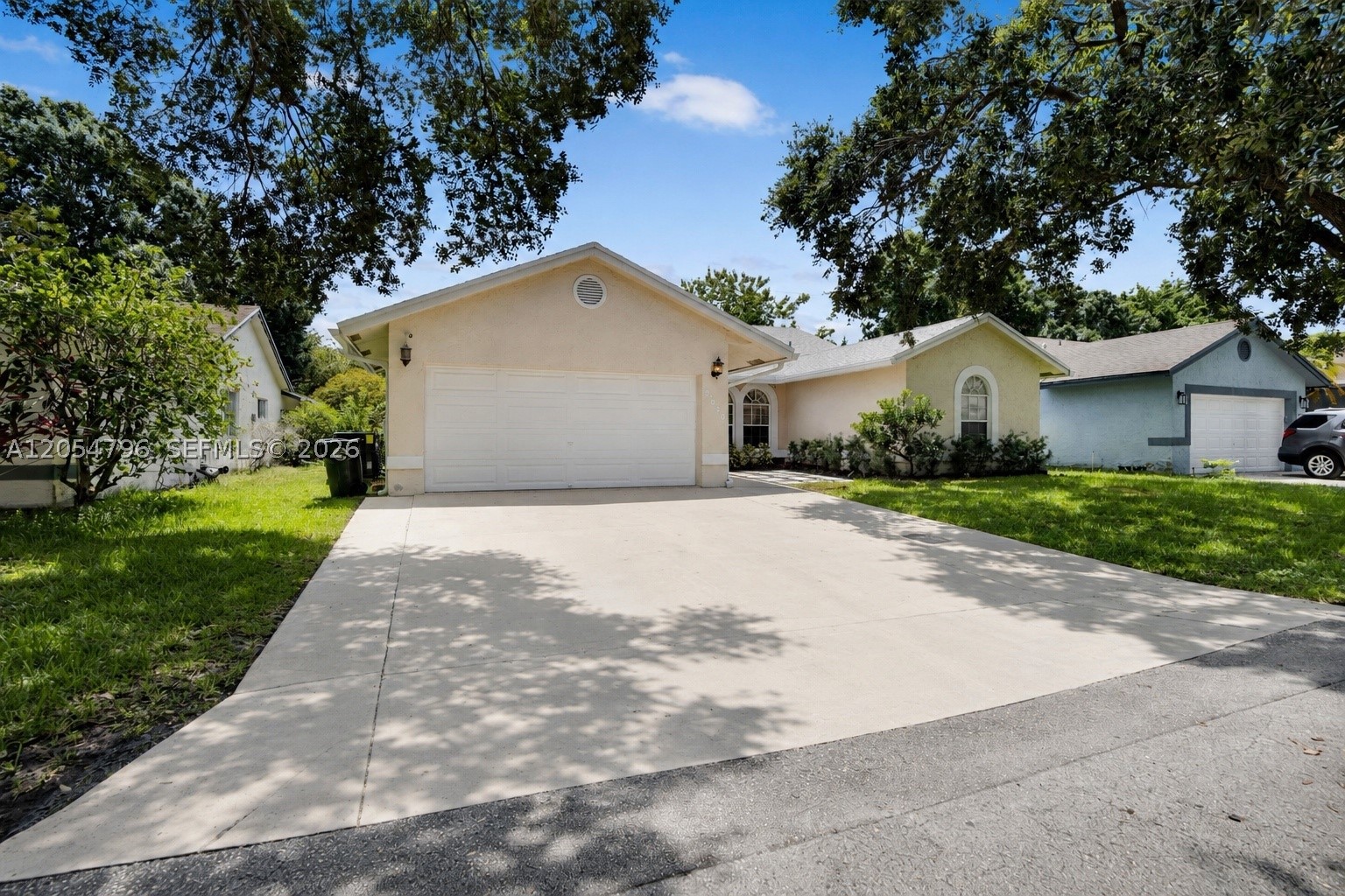 Rare opportunity to own the sought-after Beechwood model in the highly desirable Parkwood VI community. This beautifully maintained 3-bedroom, 2-bath home sits on a private waterfront lot and offers a spacious open floor plan with soaring vaulted ceilings, tile flooring throughout the main living areas, and wood flooring in the bedrooms. The fully remodeled kitchen features granite countertops, stainless steel appliances, and opens seamlessly to the bright living and dining areas. The split-bedroom layout provides added privacy, while the spacious primary suite includes a walk-in closet. Both bathrooms have been tastefully remodeled, and the interior has been freshly painted. Recent updates include a new roof (less than one year old), A/C system (less than three years old), Wi-Fi-enabled sprinkler system, automated smart blinds, hurricane shutters, and a digital water heater. Step outside to a screened patio with a sparkling pool and waterfall overlooking tranquil water views—perfect for relaxing or entertaining. Conveniently located in the heart of Coconut Creek with a low HOA