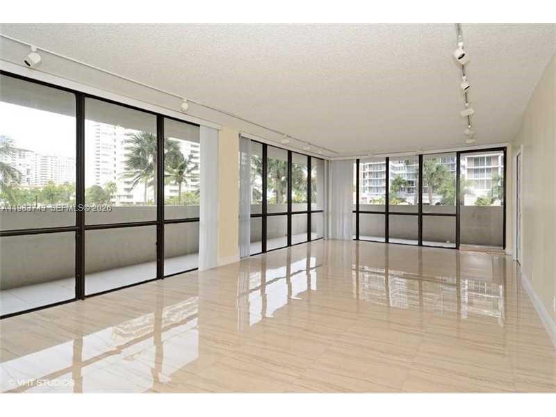Just reduced outstanding opportunity and best value for a corner unit on A1A. Renovated corner unit across from the ocean—just steps to the sand. Spacious 2-bedroom + den (with French doors, ideal as a 3rd bedroom), featuring porcelain floors throughout and a modern kitchen and baths in neutral tones. A/C only 6 months old. Resort-style amenities include a fitness center, intracoastal pool, tennis, and BBQ area. Full-service building with guard-gated entry, lobby attendant, and high-speed internet and cable included in $830/month HOA. Well-managed condominium with strong financials. Building has passed 40-year structural recertification and is in compliance with all current and future inspection requirements. Minutes to Aventura, Bal Harbour, Gulfstream, Hard Rock, major highways, and airports. Showings: Mon–Fri until 5pm, Sat until noon; no Sundays as per Mgt. Office.