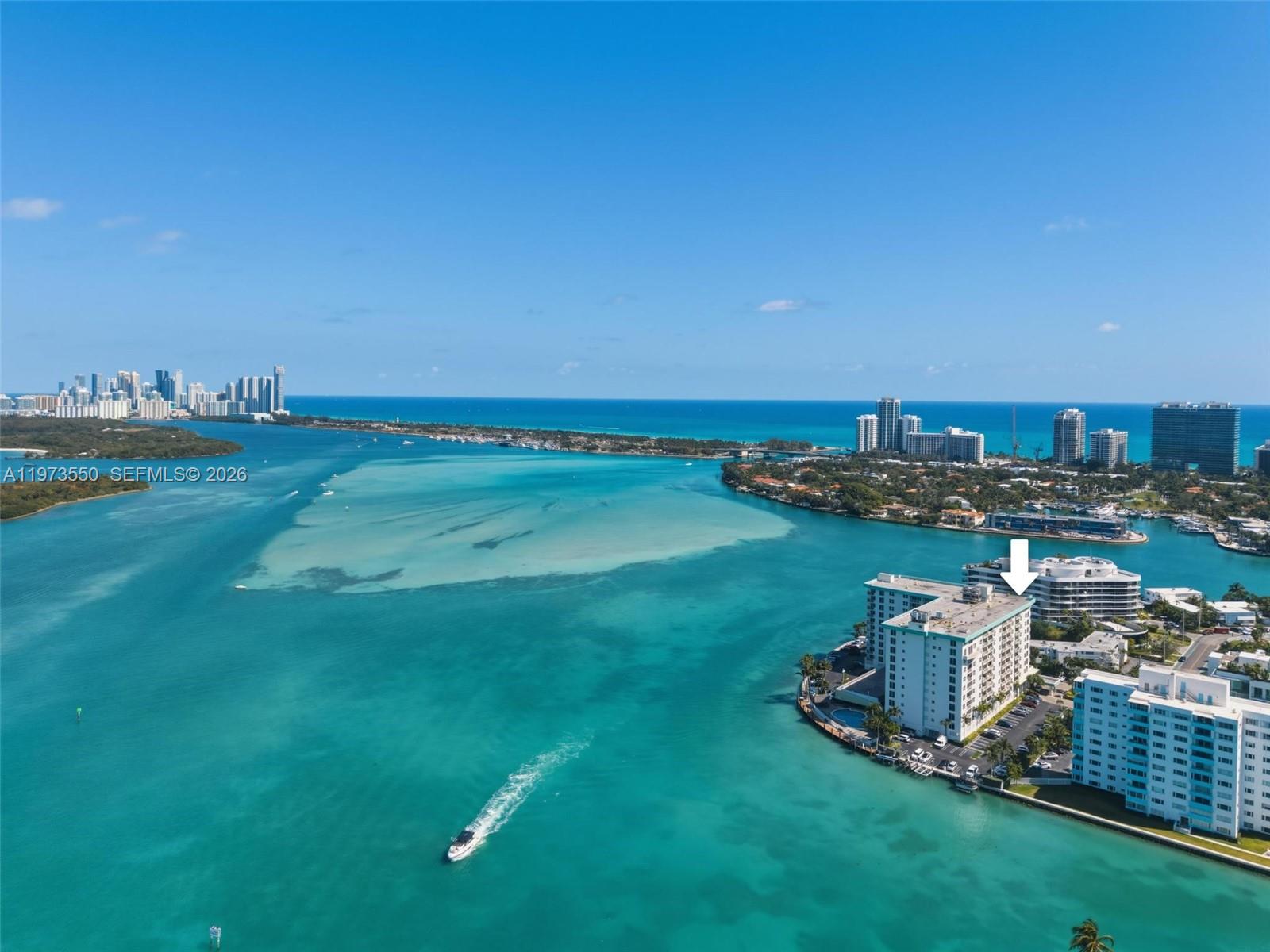 Welcome to Island Pointe, a well-maintained waterfront community in the heart of desirable Bay Harbor Islands. This 2-bedroom, 2-bath corner penthouse residence offers a split floor plan and open views of the surrounding skyline and water.  The kitchen features granite countertops, wood cabinetry and opens to the dining and living areas. The generously sized primary bedroom includes a spacious walk-in closet and a private en-suite bath. The second bedroom also has a large closet and is adjacent to the full guest bathroom. An in-unit washer and dryer add convenience, and 2 assigned parking spaces are included.  Island Pointe is a gated building with 24-hour front desk service and on-site management. Residents enjoy a waterfront pool with tiki huts, BBQ area, fitness center, community room with billiards, and boat slips that can be rented through the association. Condo fees include cable, high-speed internet, water, and air conditioning, and the building maintains reserves.  Close to Bal Harbour Shops, local cafés, the beach, and A-rated K–8 Bay Harbor school, the location also offers easy access to Miami Beach, major highways, and nearby airports. This residence presents a comfortable opportunity to enjoy a walkable island setting with convenient access to the best of the surrounding area.