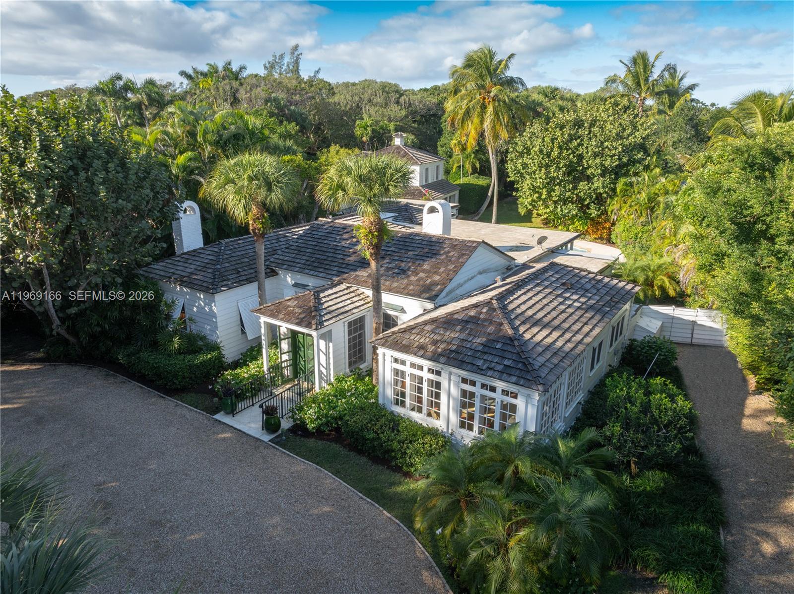This Georgian-style clapboard residence offers four bedrooms and 4.1 baths on coveted Jupiter Island, set on a rare block-deep lot with dual access from South Beach Road and Gomez Road. The property includes private, deeded beach access located directly across the street, providing effortless enjoyment of Jupiter Island's pristine shoreline. A lovely backyard creates a tranquil setting for outdoor living, complete with a private pool ideal for relaxing or entertaining. The two-car garage features a charming guest cottage above, offering additional privacy and flexibility for visitors or extended stays. Perfectly situated just minutes from shopping and dining, this home combines classic coastal elegance with exceptional location, convenience, and lifestyle appeal.