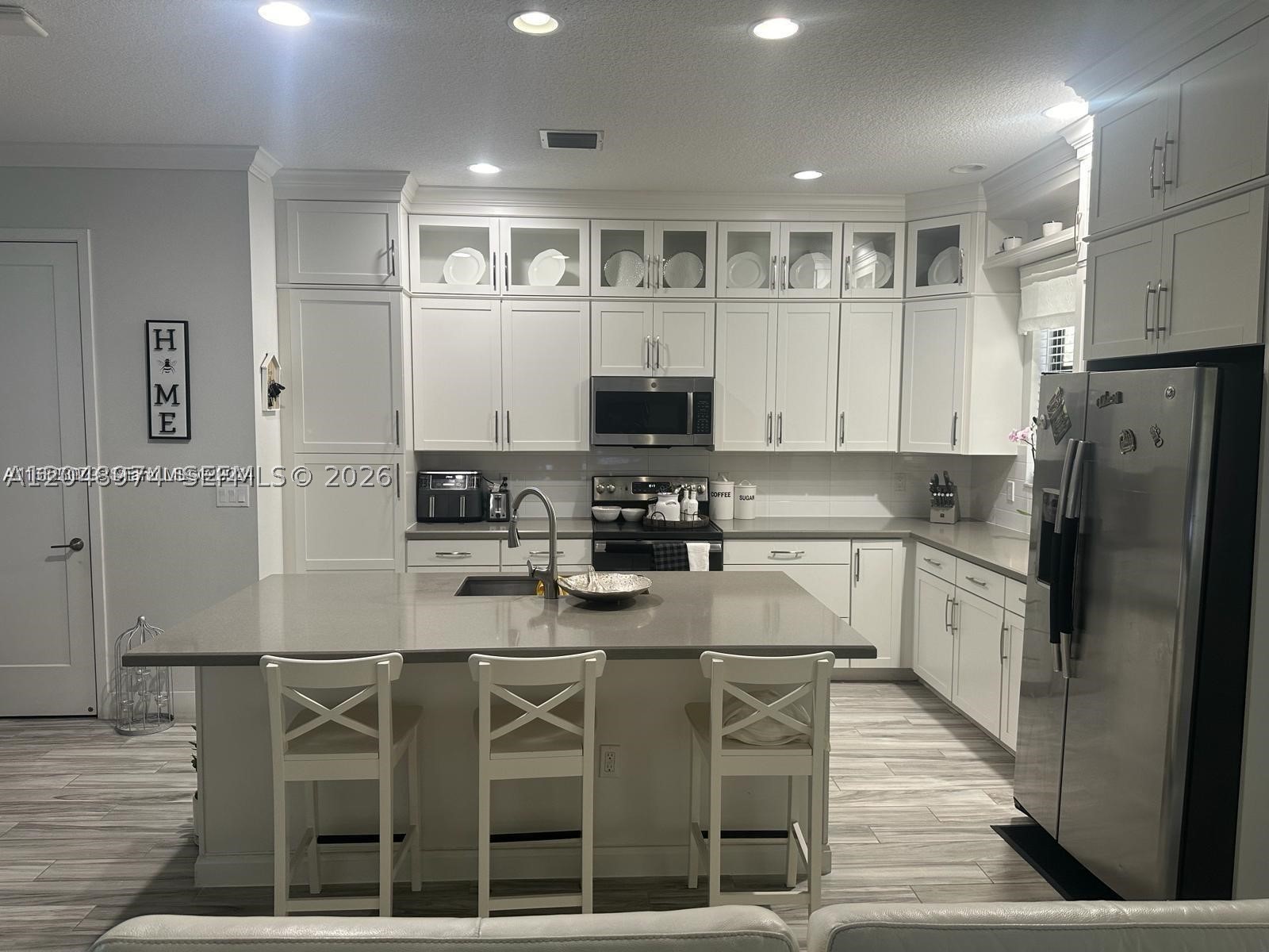 Welcome to this stunning home in the highly desirable Chapel Grove community! This beautiful 3-bedroom, 2.5-bathroom residence with a 1-car garage offers the perfect combination of style, comfort, and functionality. The first floor features an open-concept layout with a modern kitchen equipped with stainless steel appliances, elegant white cabinetry, granite countertops, and a spacious center island overlooking the living and dining areas, ideal for everyday living and entertaining. A convenient half bath and a spectacular screened patio provide the perfect space to relax or host family and friends. Upstairs, you'll find a versatile loft perfect for a home office or study area. The spacious primary suite features a large walk-in closet and a spa-inspired bathroom with dual vanities, a soaking tub, and a separate glass-enclosed shower. Two additional bedrooms, a full bathroom, and a laundry area with washer and dryer complete the second floor. Additional features include impact-resistant windows and doors, beautiful wood and ceramic flooring, and modern finishes. Residents of Chapel Grove enjoy a resort-style pool, fitness center, playground, and sports courts, conveniently located near shopping, dining, excellent schools, and major highways. Don't miss this incredible opportunity to own a beautiful move-in ready home in one of the area's most desirable communities!