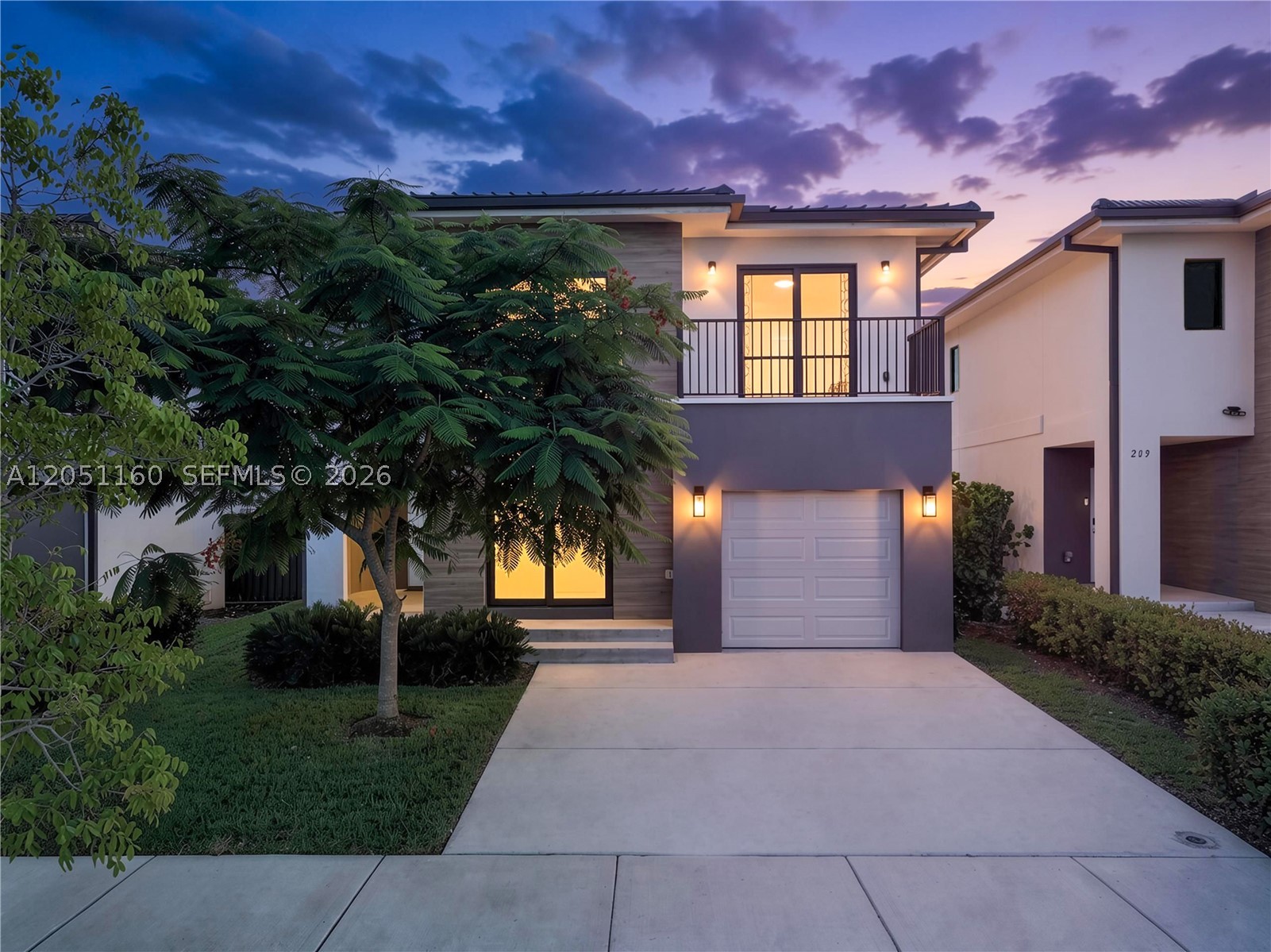 Welcome to this beautiful newer-construction home built in 2022, offering 5 bedrooms, 4.5 bathrooms, and a spacious two-story layout designed for modern living. Built with solid concrete construction, including a concrete second floor instead of standard wood framing, this home offers exceptional durability and peace of mind. Complete impact windows and doors provide added storm protection, energy efficiency, and security. The open-concept floor plan seamlessly connects the living, dining, and kitchen areas, creating the perfect space for everyday living and entertaining. The kitchen features stainless steel appliances, stone countertops, a double sink, and abundant cabinet space. This thoughtfully designed home offers exceptional flexibility with one primary bedroom and two junior primary bedrooms. A first-floor junior primary bedroom with a private bathroom is ideal for guests or multigenerational living. Upstairs, you'll find the spacious primary bedroom with a walk-in closet and en-suite bath featuring dual vanities, plus a second junior primary bedroom with its own private bathroom. A one-car garage and expanded driveway provide ample parking, while the fully fenced backyard offers privacy and space to relax or entertain. Located in a desirable neighborhood with a very low HOA, this move-in-ready home is minutes from the Florida Turnpike, schools, shopping, dining, parks, and major highways. Enjoy the immersive 3D virtual tour. May your best start here.