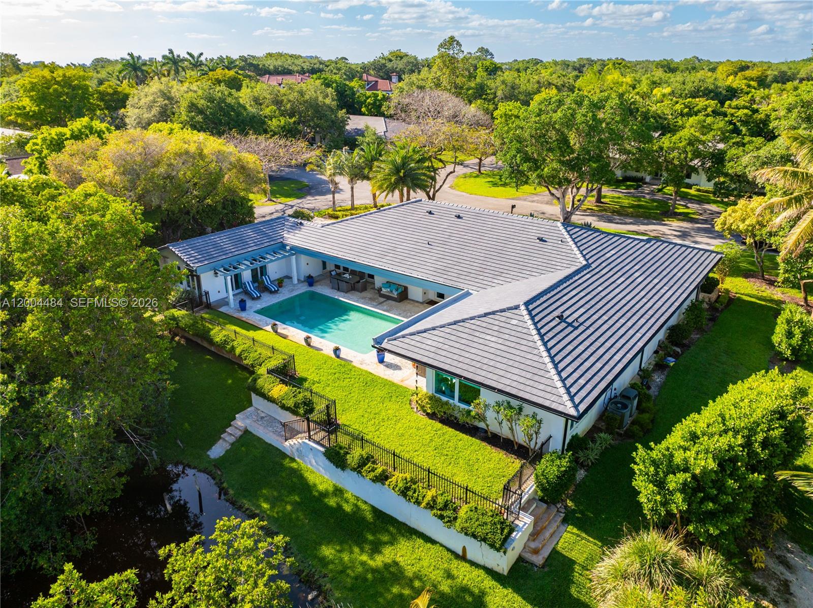 Tucked away on a quiet South Gables cul-de-sac, this meticulously renovated 5 bedroom, 4.5 bathroom home spans 5,078 square feet on a lush 15,657 square foot lot with no neighbors on two sides!  The deep front porch welcomes you to an entertainer’s dream home with formal living and dining rooms, large family room, and a stunning chef’s kitchen with eat-in area, butler’s pantry, and wet bar all overlooking the pool and patio area.  The private primary suite includes beautiful built-ins, a large walk-in closet, and a serene, spa-like bathroom with soaking tub and infrared sauna. 3 additional bedrooms are located by the primary bedroom, with the 4th across the house.  There are gorgeous mahogany floors, complete impact glass windows and doors, a brand new roof, and much more with the amenities of Coral Gables, but in the coveted Pinecrest/Palmetto school district.
