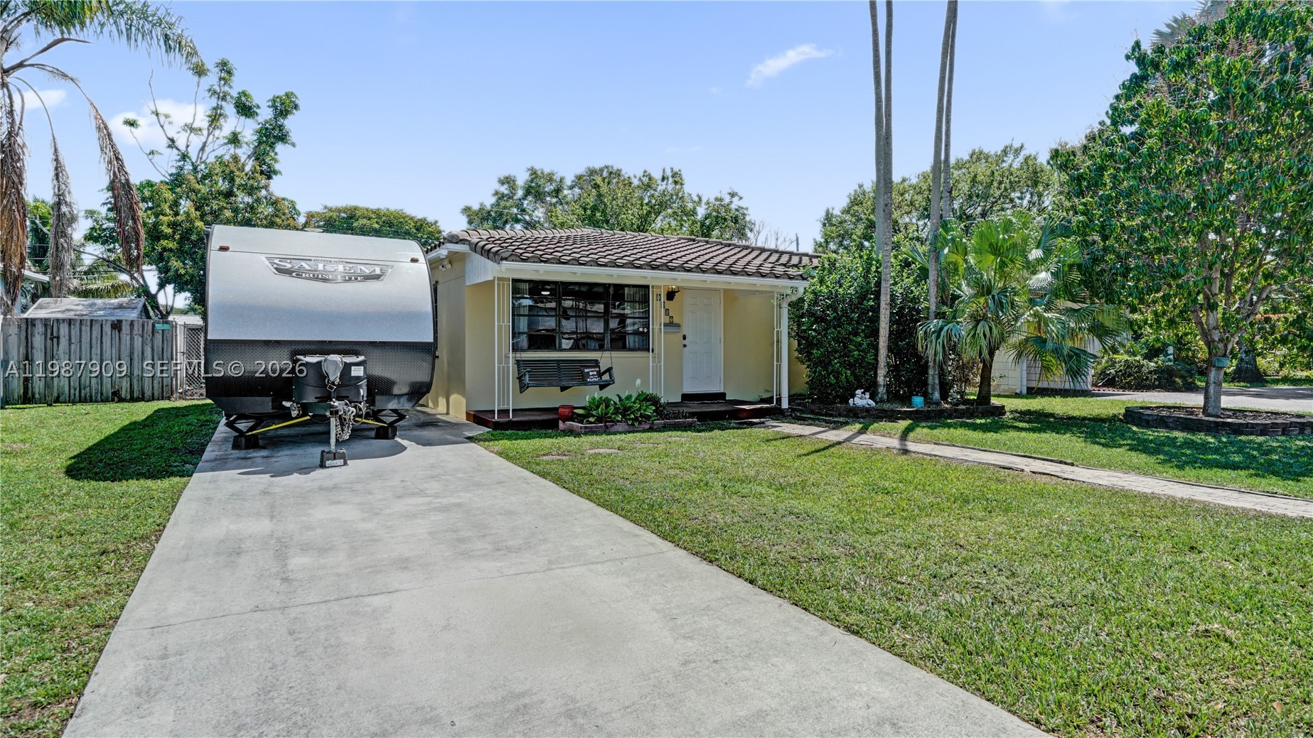 Charming 3-bedroom, 2-bath Hollywood home ideally located just a short bike ride to Hollywood Beach, Hollywood Blvd, the YMCA, Farmers Market, Rotary Park, and TY Park. The spacious backyard is perfect for relaxing or entertaining, featuring a swing set, mature avocado tree, and a 2021 all-metal 10x16 ft Lark shed. Inside, brand new vinyl flooring (2026) flows throughout, giving the home a fresh, modern feel. Enjoy year-round comfort with central AC (2021) plus a split unit in the primary bedroom (2024). The primary bathroom was fully updated in 2022. A long driveway offers ample space for an RV/boat and multiple vehicles, while a mango tree in the front yard adds to the home’s charm. The house is connected to a gas line for added efficiency with a gas range and water heater. This well-maintained property is truly move-in ready! NO HOA