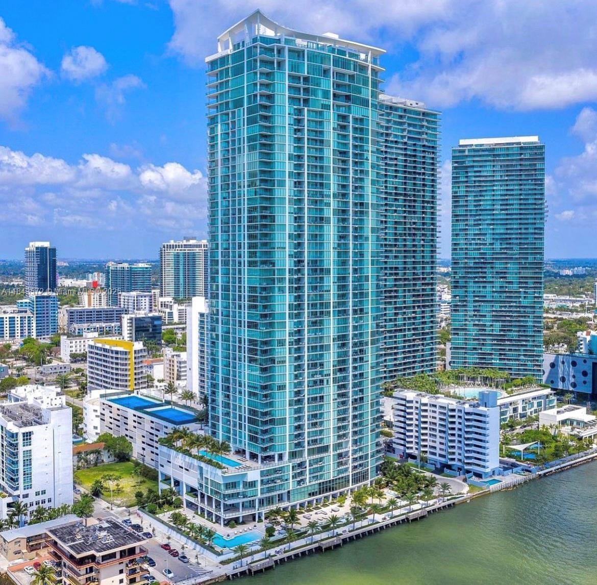 Magnificent bay and city views from this beautifully furnished 2BD/2BA in one of Edgewater’s most luxurious buildings. Enjoy golden hour natural light, floor to ceiling impact windows, marble floors, a private balcony, and private foyer. The second bedroom has been converted and can serve as an office. Modern kitchen with top-tier appliances. Resort-style amenities include a bay front pool, 2 tennis courts, basketball court, fitness center, spa, sauna, steam room, salon, massage rooms, cabanas, BBQ area, business center, valet, concierge, market, dog relief area, and 24-hr security. Text to schedule a private showing. Building is going through renovations. Rental rate has been adjusted to reflect limited balcony access due to ongoing building repairs.