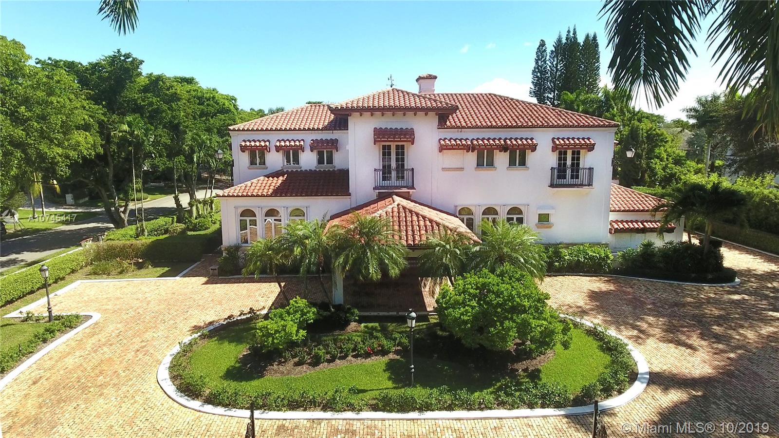 NEW PRICE!!! Spanish Colonial estate w/classic finishes in prestigious Cocoplum on 32,563 sf corner lot, this home was built w/fine craftsmanship, beautiful architectural details & materials hand-selected in Spain. Iron-gate entrance & wooden 17th century Spanish Monastery double door lead to the double story central fountain atrium lit by a skylight. The formal living & dining rms feature hardwood flrs. The eat-in-kitchen leads to the family rm & cabana rm. Staff quarters are adjacent to the kitchen. A beautiful staircase leads to the 2nd flr den, main suite & terrace, 2 more bedrms & bath. A marvelous L-shaped covered terrace overlooking the pool, patio area & yard, w/generous entertaining spaces. Full house diesel generator. Property is located in a special taxing district.