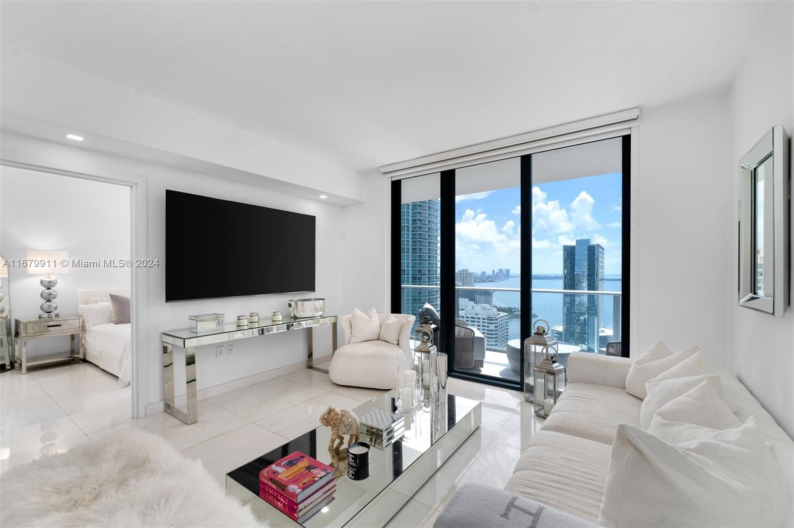 This stunning 2 Bed/3 Bath + Den apartment in Brickell is fully furnished and offers breathtaking views of the Bay. Designed with a "concept of all white elegance," it features luxurious marble flooring, custom closets, automatic blinds and an Italian-designed kitchen. The upgraded lighting includes electric dimmer switches, creating a bright and glamorous atmosphere.

The unit comes with 2 parking spaces, access to unparalleled amenities, including a rooftop pool, indoor pool, outdoor theater, a state-of-the-art fitness center with Peloton bikes, a spa with a steam room, sauna, jacuzzi, and cold plunge, along with a massage room, playroom, arcade room, squash court, basketball court, and exercise trail. Just steps away from the best restaurants & a few blocks from Brickell City Center.