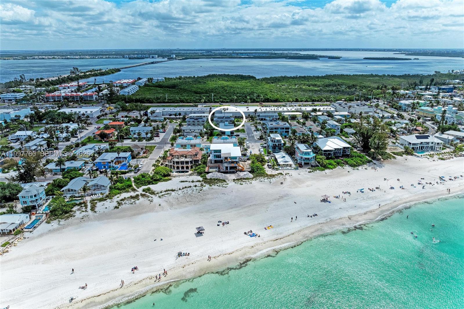Turn-key furnished 2BD/2BA condo located directly across the street from the white sandy beaches of Anna Maria Island in Holmes Beach. This 1,569 sq ft TA unit offers a desirable two-level layout with living areas on the main level and bedrooms upstairs, each with its own private balcony. Open kitchen with island flows into a bright living space. Ceramic tile flooring throughout main areas. Community features a recently remodeled pool and fenced green area. Ideally located near restaurants, grocery stores, pharmacies, and shopping. Short-term rentals allowed, making this an excellent income-producing opportunity or perfect island getaway. Enjoy the charm of Anna Maria Island, known for its beautiful sunsets and relaxed coastal atmosphere, offering a wonderful setting to unwind and spend quality time by the beach.