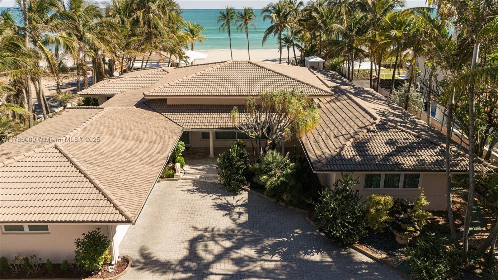 Experience exclusive coastal living in this one-of-a-kind estate, situated on one of the last remaining double lots on the ocean in prestigious Golden Beach. This 4-bedroom, 4.5-bathroom home offers 4,144 square feet of
elegant living space and a spacious two-car garage. Set on a 30,200 square-foot lot with 100 feet of direct Atlantic Ocean frontage, the property provides unmatched privacy and breathtaking views. With private beach access, this rare gem includes a backyard that serves as an outdoor oasis, ideal for entertaining and relaxation. It features a covered open-air summer kitchen, an oversized pool, and a full bathroom. Enjoy the charm of historical accents combined with the luxury of waterfront living, along with access to exclusive tennis courts and a playground.