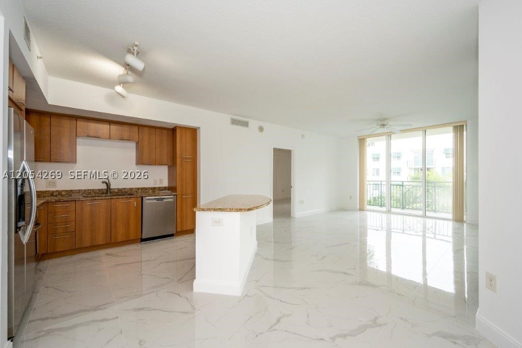 Spectacular apartment with beautiful porcelein floors overlooking the pool! This residence offers granite countertops, stainless steel kitchen appliances, European-style cabinetry, a marble shower with soaking tub, smart key FOB building entry, and an in-unit washer and dryer. Building amenities include a stunning lobby, resort-style tropical pool and jacuzzi, fitness center, dry sauna, 24-hour manned front desk, and a high-tech security system. Ideal location close to Plantation Walk, Sawgrass Mall, Westfield Broward Mall, and minutes to FLL airport. Maintenance covers water, internet, and cable TV. Included are two assigned parking spaces in the secure garage.