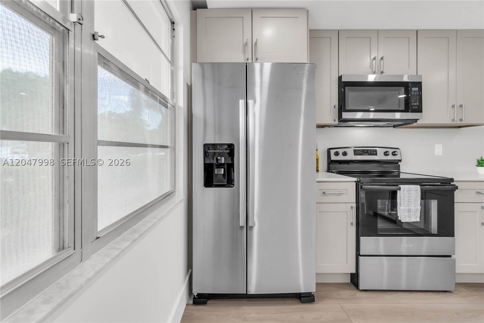 Completely remodeled 2-bedroom, 2-bathroom condo with beautiful lake views! This light-filled apartment features an open-concept floor plan, a stunning kitchen with stainless steel appliances, and modern finishes throughout. Enjoy smooth ceilings with no popcorn, recessed lighting, and contemporary flooring. Both bathrooms have been fully renovated with brand-new walk-in showers, while the spacious primary suite offers a double-sink vanity for added convenience. Relax on your private patio overlooking the lake and enjoy the perfect combination of style, comfort, and functionality. Move-in ready! Located in a desirable 55+ resort-style community offering exceptional amenities, including pools, clubhouse, fitness center, golf, tennis, pickleball, theater, courtesy transportation, and countless social activities. A must-see!