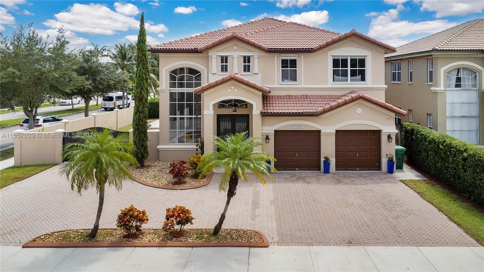 Corner, Mediterranean style house with 4 bedrooms and 3 bathrooms, with pool and lots of entertainment space in the highly desirable area of Tamiami. This house with 3,200+ sq. ft. of construction is a two-story single-family residence very well maintained. Security system and cameras come with the house. High ceilings throughout and stunning ceramic floors. A full bedroom and bathroom downstairs for convenience. Ample Family room with pre-wiring for buyer's surround system. The eat-in kitchen has stainless steel appliances, ceiling-high cabinets, and double sink. The backyard has a covered terrace with travertine tiles and a full kitchen, perfect for outdoor entertainment. Convenient side entrance to park additional cars or toys, in addition to the large driveway and double car garage.