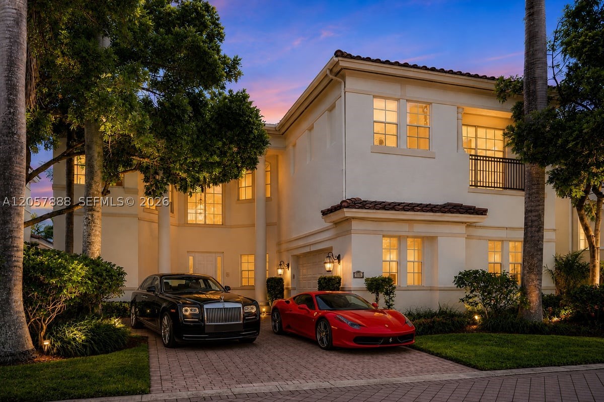 Experience timeless elegance in this spectacular 5-bedroom, 6-bath Mediterranean waterfront estate offering nearly 4,500 square feet of luxurious living space. A grand two-story foyer welcomes you with soaring ceilings, polished natural stone floors, dramatic Tuscan-inspired columns, and abundant natural light. The thoughtfully designed floor plan blends formal elegance with comfortable everyday living. At the heart of the home, the gourmet kitchen showcases rich black stone countertops, custom white cabinetry, premium stainless steel appliances including double wall ovens, a built-in microwave, an oversized side-by-side refrigerator, a spacious center island, and an expansive peninsula perfect for entertaining. A stunning travertine staircase with decorative wrought iron railing, solid wood handrails, and custom newel posts serves as a striking architectural centerpiece. Expansive living areas flow seamlessly to covered lanais, creating the ideal indoor-outdoor lifestyle. Upstairs balconies framed by classical white columns and elegant metal railings overlook peaceful waterfront surroundings, offering the perfect setting for morning coffee or spectacular sunset views. The smooth stucco exterior, classic barrel-tile roof, and refined Mediterranean architecture create exceptional curb appeal, while generous living spaces and timeless craftsmanship make this residence ideal for entertaining, relaxing, and enjoying the best of luxury waterfront living. Property virtually staged