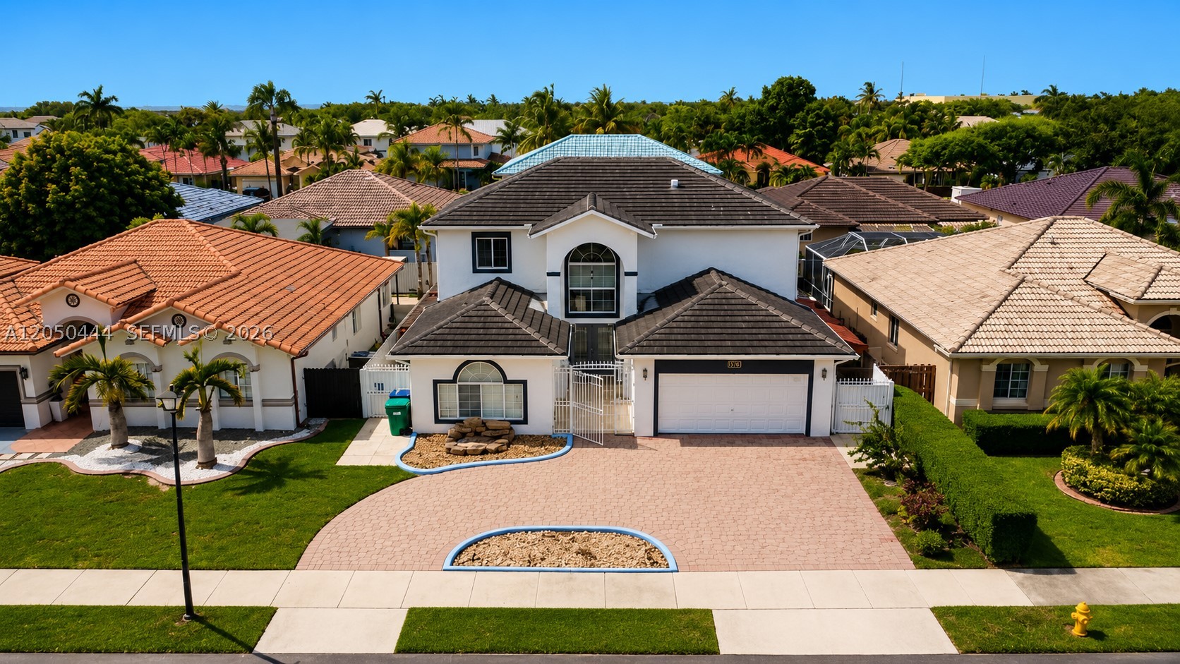 Magnificent, renovated single-family home featuring a heated saltwater pool. It offers 6 spacious bedrooms and 4.5 bathrooms, with no HOA fees. There are two master suites—each with its own bathroom—located on separate floors; the upstairs suite includes dual walk-in closets. Features include porcelain flooring, a glass staircase, impact-resistant windows and doors, a pergola, and travertine paving throughout the patio and side yards. Recent upgrades include a new roof (2022), new fencing (2021), custom closets (2021), and stainless steel appliances (2021), plus a hurricane-ready backup power system. The property boasts a spacious circular driveway, a security camera system, and an alarm system. Located in a fantastic West Kendall neighborhood, just 3 minutes from Publix and Walgreens, and 8 minutes from Walmart, BJ's, and The Home Depot.