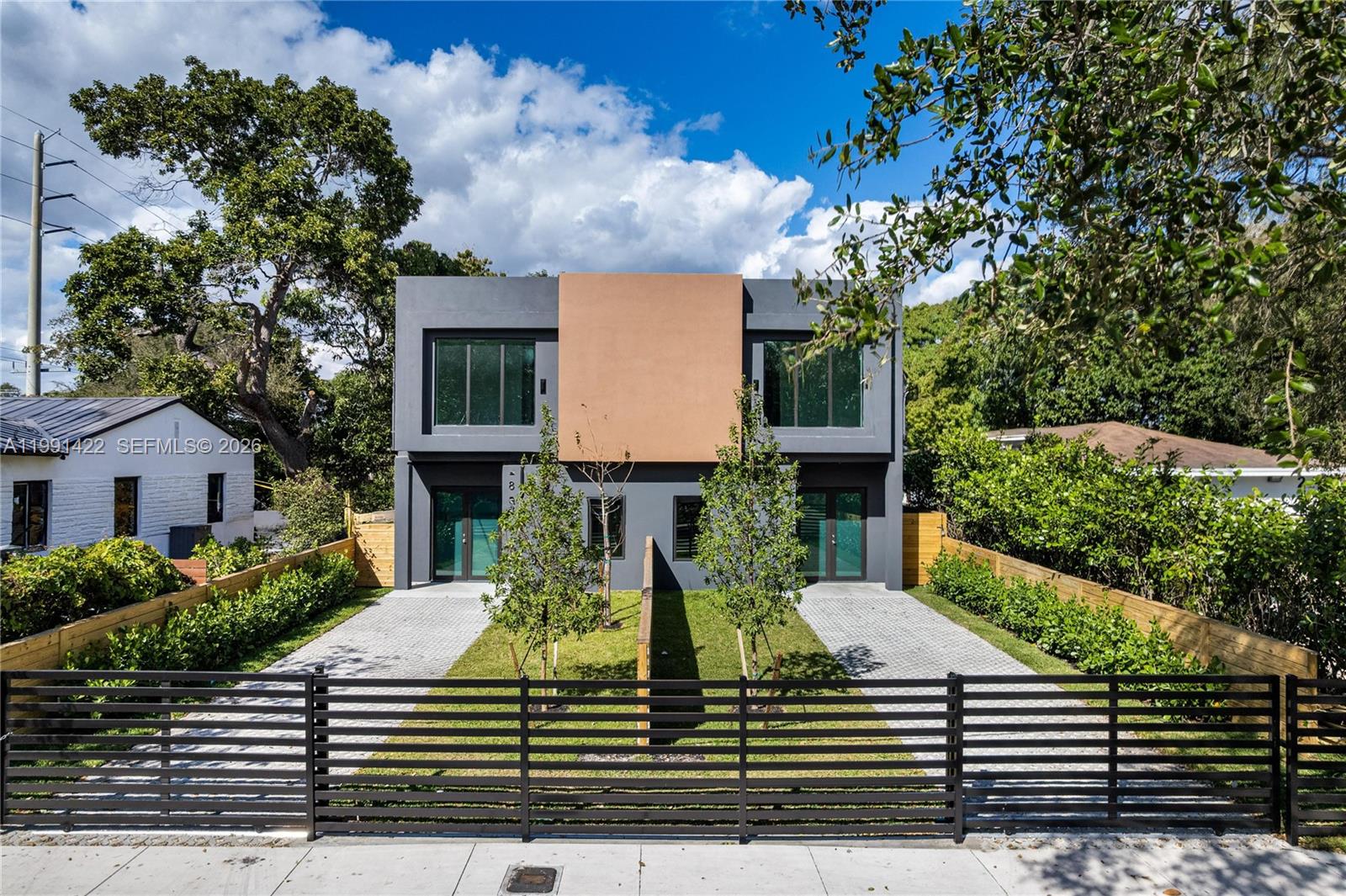 Step into modern elegance in this rare 2,450-square-foot residence — a size that’s increasingly hard to find in the area. Designed to impress from the moment you arrive, the home features a dramatic tall front door, soaring high ceilings, and a bright, open layout that feels both luxurious and welcoming. The heart of the home is a chef’s kitchen with fully custom cabinetry, designed for both beauty and function. It features a stunning Taj Mahal quartzite countertops and outfitted with premium stainless-steel appliances, including an integrated refrigerator for a seamless, high-end look and a built-in wine cooler—perfect for entertaining or everyday enjoyment. Both the kitchen and bathrooms feature fully custom cabinetry, elevating the home with clean lines, quality craftsmanship, and generous storage throughout. Function meets style with a spacious laundry room, ideal for organization and daily convenience—an often-overlooked luxury that truly enhances everyday living. Outdoors, enjoy your own private pool and gated driveway, creating a secure and serene oasis for entertaining, relaxing, or soaking up Miami’s sunshine. Whether you’re looking for a primary residence, a long-term rental, or a high-performing Airbnb opportunity, this property offers incredible versatility and appeal. With its modern design, and generous square footage, it’s suited for both personal enjoyment and income potential. This is more than a home — it’s a lifestyle and an opportunity.