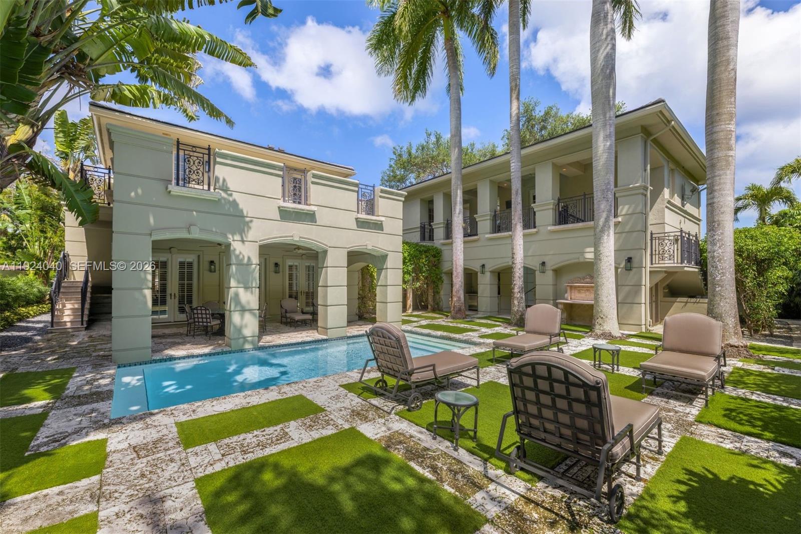 Nestled within the prestigious gated community of The Moorings, this 8,811 SF residence offers a harmonious blend of classic elegance and everyday comfort. The 5-bedroom, 5-bathroom plus 2 half-bath estate is surrounded by rich landscaping, providing a sense of privacy and tranquility. Inside, the home features soaring ceilings, exquisite architectural millwork, and high-impact French doors that fill the interiors with natural light. Formal living and dining areas, a stately marble fireplace, an office, elevator, and staff quarters create a refined yet functional layout. Step outdoors to a resort-style setting complete with a shimmering pool, multiple terraces for alfresco dining, a fully equipped summer kitchen, and a peaceful courtyard fountain. Additional highlights include a 2.5-car garage with space for a sports car, a generator, and a new roof—offering both sophistication and practicality in one exceptional Coconut Grove estate. The adjacent 17,820 sq ft lot is also available for purchase (MLS A11924027), creating a rare opportunity to assemble a combined homesite within one of Coconut Grove’s most coveted enclaves.