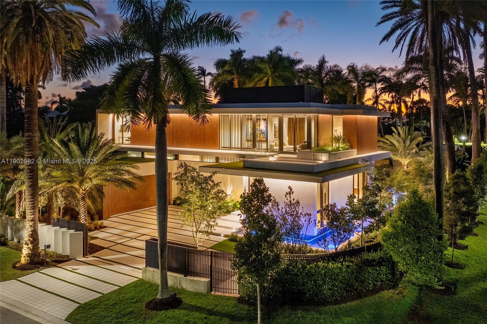 Tropical modern elegance redefined. Welcome to this newly built 6,000 SF estate on the exclusive guard-gated Sunset Islands. This striking collaboration by Sunlight Homes & Preschel Bassan features 5 elegant bedrooms plus staff quarters, with 7 full and 2 half baths. A stone-clad façade opens to Boffi kitchens, imported stone, and Spanish oak floors. Interiors by Tamara Feldman feature handcrafted details from fluted leathered marble, hingeless doors, Delta lighting, travertine, and limestone. The primary suite includes a terrace, dual baths and dressing rooms. Outside, a private resort unfolds with pool, cold plunge, spa, and summer kitchen. Complete with elevator, smart-home integration, and generator. The residence is set on a 12,000 SF corner lot with immaculate sunset and water views.