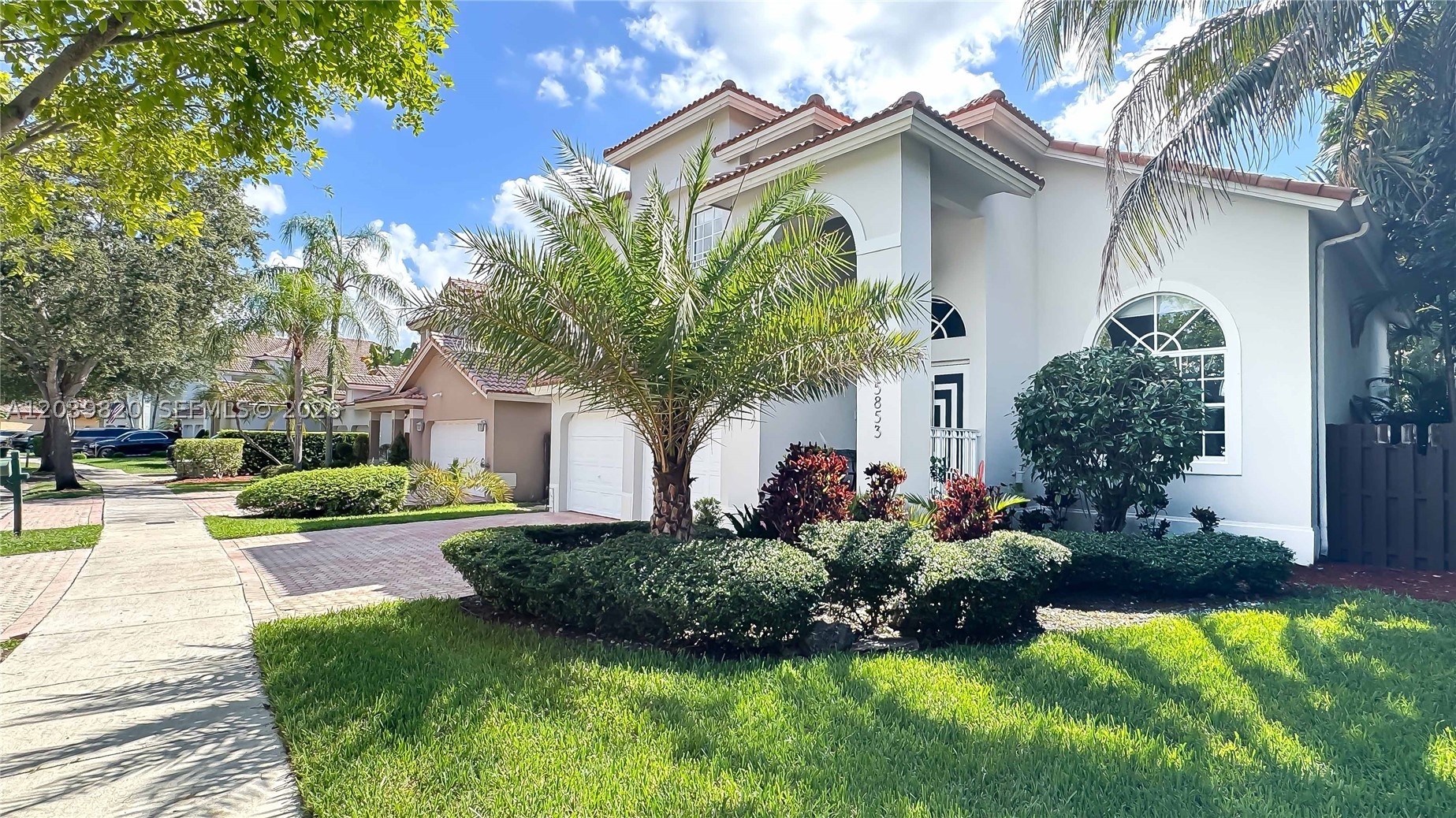 Enjoy living in this beautifully remodeled home located in the highly sought-after Doral Isles community. This gated and patrolled neighborhood is renowned for its resort-style amenities, including a state-of-the-art fitness center with daily classes, three expansive swimming pools, event spaces, basketball, soccer, tennis courts, on-site restaurant, playgrounds, and a variety of community activities. This stunning residence features fully renovated bathrooms, a modern kitchen with new cabinetry and brand-new stainless steel appliances, elegant stainless steel stair railings, and a beautifully landscaped backyard perfect for entertaining and relaxing. Additional upgrades include a new refrigerator, dishwasher, range, microwave, garbage disposal, new downstairs A/C unit, and a new water heater. Conveniently located near top-rated A+ schools, shopping, dining, and major highways. A true move-in-ready gem!