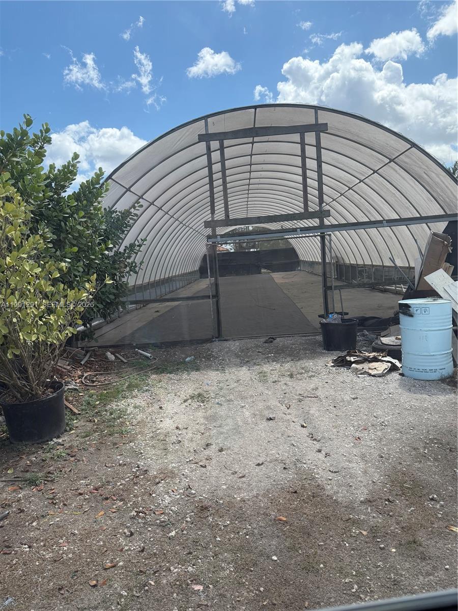 Great Area located in the Redlands Agricultural district, few blocks from Krome-excellent area.  For rent ONLY one large green house ready with electricity, irrigation/water, above ground planters ideal for Hydroponic vegetable/plant growing. Monthly rent $1,700.00. Located in a 5 acre agricultural land, fully fenced/ security system. Call for further information.