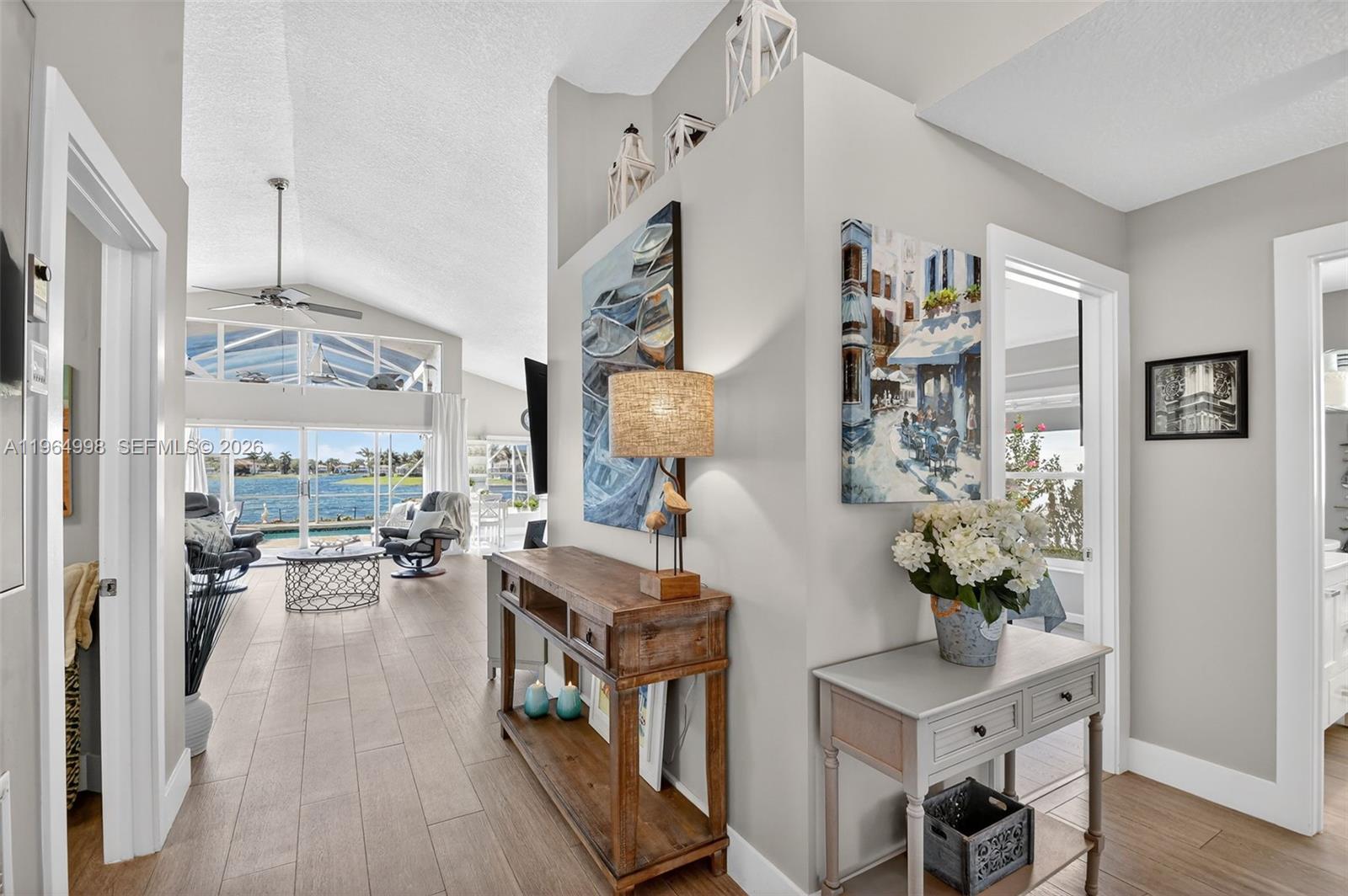 Completely remodeled 3-bedroom, 2-bathroom waterfront single-family home in the highly desirable Lake Charleston community! This beautifully updated residence offers breathtaking water views and unforgettable sunsets. Enjoy true Florida living with a resurfaced saltwater pool featuring a heater and spa with jets, new ceramic finish, screened porch, and child safety fence. The open layout showcases stunning lake views, a modern white kitchen with abundant cabinetry and stainless steel appliances, and a desirable split floor plan. The private primary suite is situated on its own side of the home for added comfort. Additional highlights include a utility room with new washer and dryer, 2-car garage, new sprinkler pump drawing water from the lake, owned solar panels for the water heater, roof (2016), and A/C (2020). Porcelaine flooring throughout and laminated wood floor in the guests bedrooms.Beautiful landscaping surrounds the home, including a striking Sylvester Palm with diamond cut in the front yard. Located on a large lake allowing non-motorized watercraft and battery-powered boats. Residents enjoy a clubhouse with two pools, pickleball, and tennis courts. All ages welcome. Internet & Cable are included in the fees. Zoned for three A-rated schools. Don't wait, it will be too late!