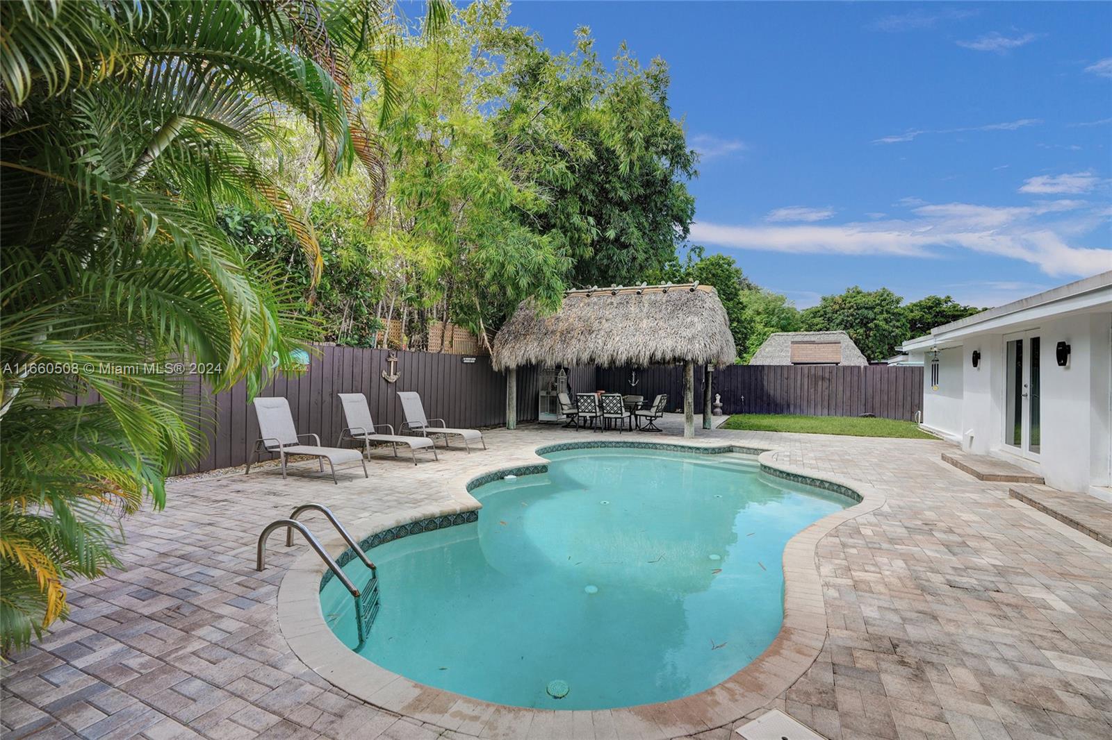 Immaculately maintained 4-bed, 2-bath home in the desirable, gated community of Keystone Point. Featuring an open-concept layout with high vaulted ceilings, this home is flooded with natural light. Enjoy the modern kitchen with updated appliances, remodeled baths, & tile floors throughout. Relax or entertain in the spacious backyard, complete with a tiki hut, beautifully paved pool, & covered RV & boat parking. Hurricane impact windows & doors provide added protection. Located east of US-1, mins from Publix, Whole Foods, Costco, top restaurants, & Bal Harbour Shops. Walk to Bal Harbour Shops or the beach, & enjoy the community marina, children’s park, nearby tennis & golf courses. A great neighborhood for families, just 10 mins to Aventura & 15 mins from Miami Beach
