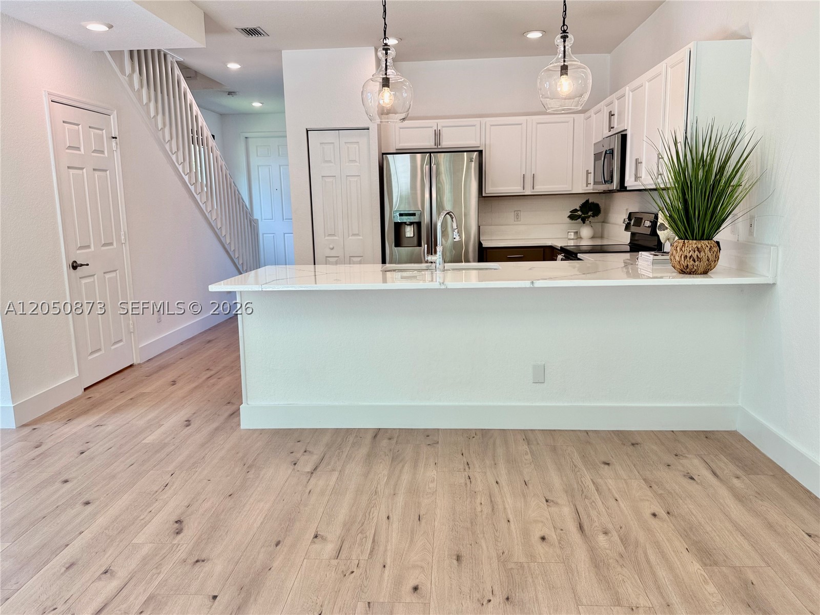 You'll fall in love at first sight with this spectacular townhome! This beautiful corner property has been completely remodeled to offer comfort, style, and modern upgrades. It's bright and spacious. This spacious 2-bedroom, 2.5-bath home features a bright open floor plan. Enjoy an open layout with fresh paint, new flooring, modern finishes, and abundant natural light. Walk-in closets. The kitchen and bathrooms have been renovated, making this the perfect home for those seeking functionality and charm. It also features a private, fenced backyard, ideal for relaxing or entertaining. Located in a quiet, family-friendly gated community with easy access to Downtown West Palm Beach, shopping, restaurants, schools, and major highways. And yes, pets are welcome. Don't miss this opportunity!