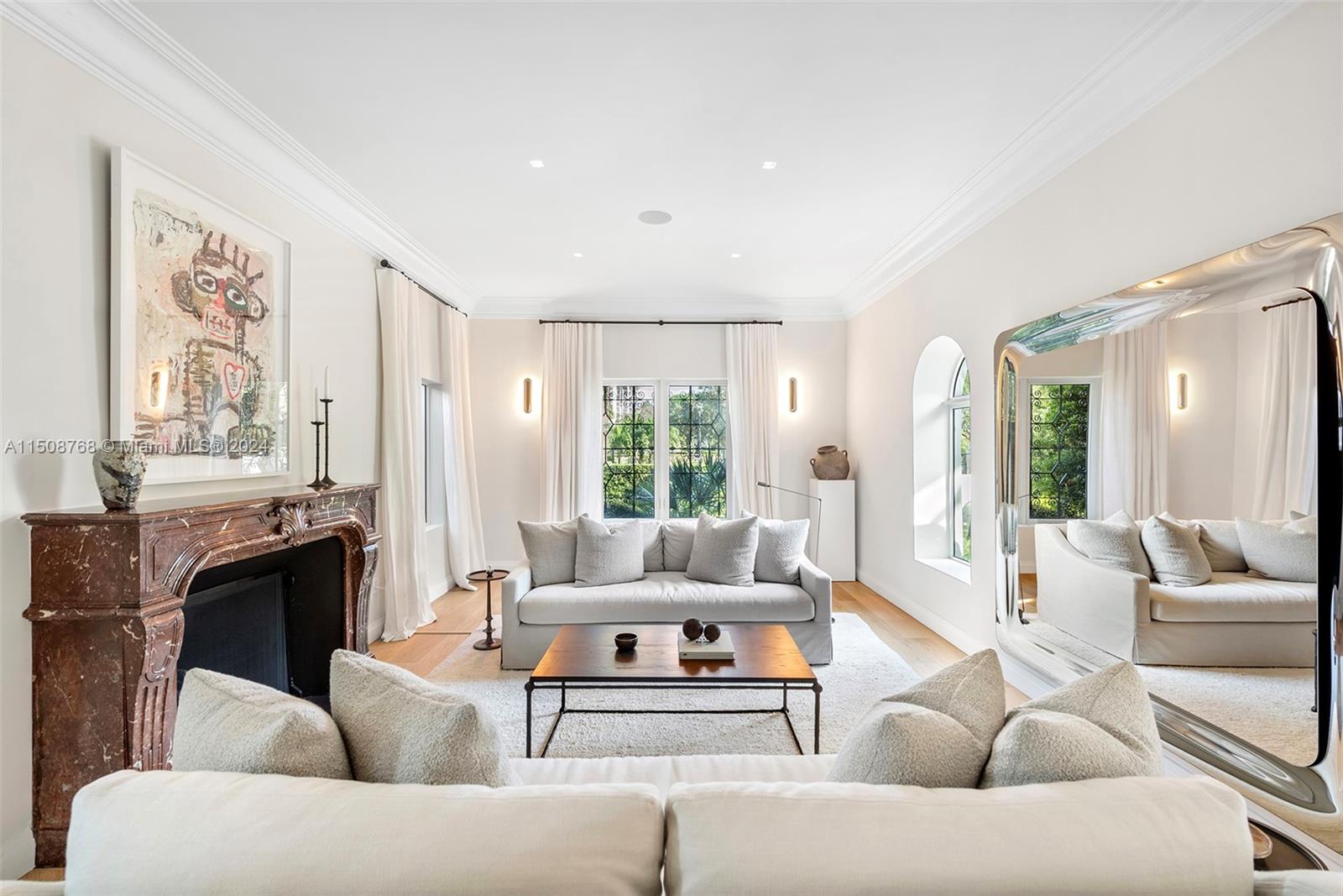 No expense was spared while remodeling this gated 2-story, 5-bed/ 3.5-bath home on prestigious Pine Tree Drive! Standout details include a large Arrital Italian kitchen w/ Miele and SubZero appliances, butler’s pantry, formal dining room, home theater, summer kitchen & stunning bath w/ book-matched Arabescato marble. Modern finishes include impact windows, new oak flooring, linear diffusers, Smart Home Crestron system controlling lighting, shades & 5 music zones, mosquito system and security cameras. A large living room w/ a Louis XV gas fireplace shipped from Europe & spacious backyard overlooking lushly manicured grounds. Oversized primary suite with a generous walk-in closet & marble bath exudes luxury. Premier neighborhood close to beach, A+ schools, La Gorce Country Club & top dining.