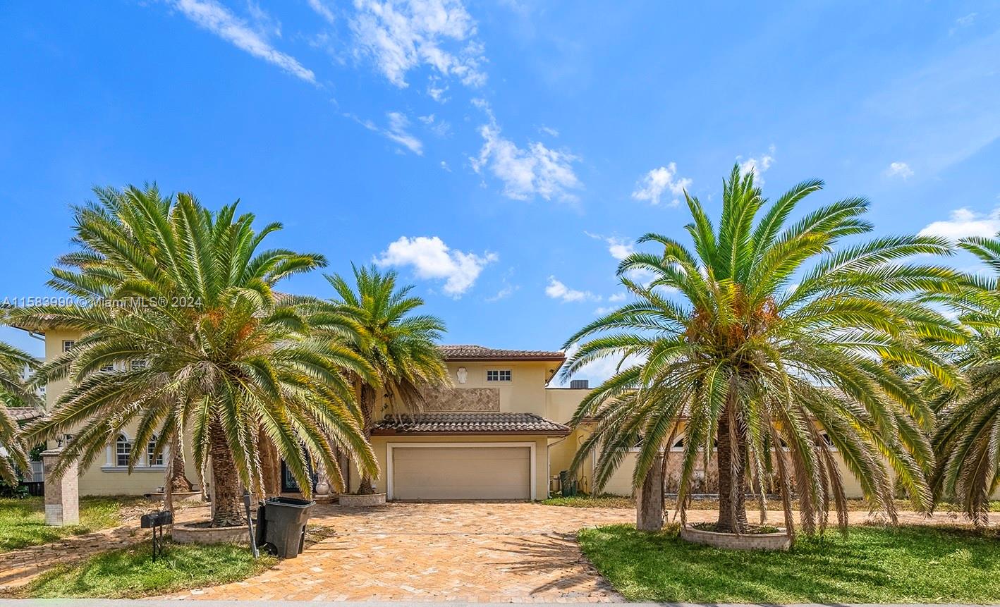 Mediterranean-style masterpiece nestled on a double lot along the waterfront. This two-story sanctuary boasts six bedrooms and six bathrooms, spread across 8,512 square feet of impeccable design. Chef's kitchen adorned with granite countertops and top-of-the-line stainless steel appliances, beckons culinary enthusiasts. With 160 feet of water frontage offering direct ocean access and no fixed bridges, indulge in the ultimate boater's paradise. Take a dip in the refreshing pool or unwind in the soothing spa while relishing the picturesque views. Elegance abounds with marble and wood floors throughout. Bring all offers.