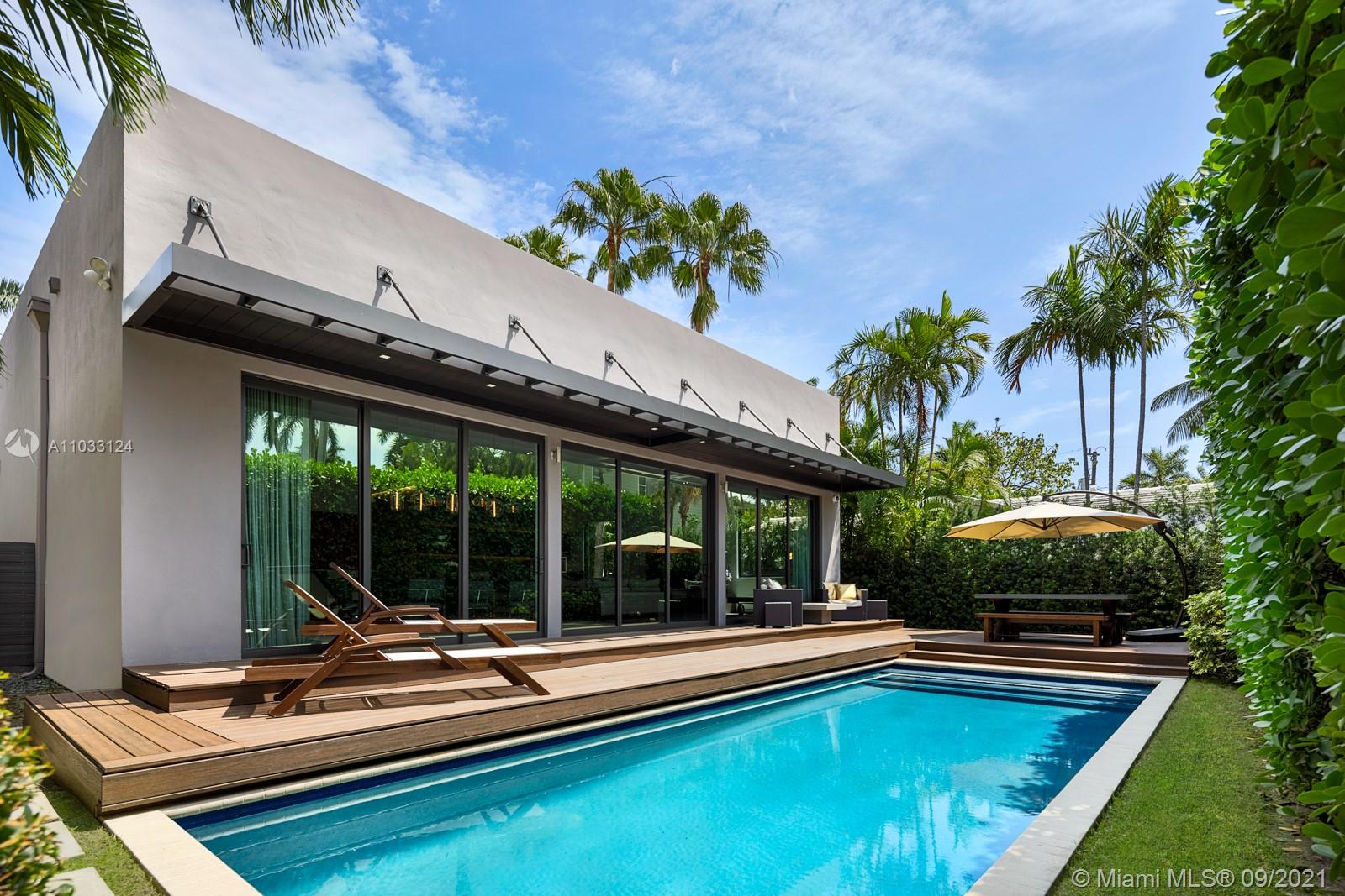 Step Inside this newly built modern minimalist home on the coveted Venetian Islands. This tucked away oasis features 4 bedrooms, 4 bathrooms, and a premium Savant System for ultimate convenience. No detail was spared from exterior to interior. At first glance, the front exterior custom walnut millwork is complimented upon entrance with travertine walls, the upgraded lighting systems throughout and ceiling heights extended up to 11 feet. Experience simple sophistication as you enter through the foyer and into the grand living area that embodies an open concept design with the kitchen, dining, and living room.  Telescopic sliding glass doors create an ideal indoor-outdoor entertaining environment by the pool, surrounded by lush landscaping for ultimate privacy.