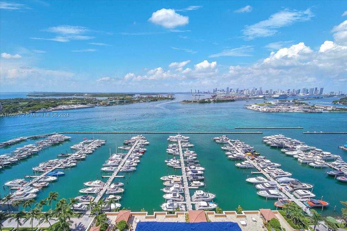 Indulge in unparalleled luxury living with this captivating split floor plan waterfront gem in the world renowned South of Fifth neighborhood! Gaze upon breathtaking sunsets and vistas of Biscayne Bay and the iconic Miami skyline from every angle of this stunning beach home nestled in the prestigious Yacht Club at Portofino. Experience the spectacle of vibrant yachting and cruise ship activity from your private balcony, offering an exclusive front-row seat to Miami's dynamic waterfront scene. Revel in the modern comforts of a host of upgraded amenities including a bayfront pool deck, tennis court, BBQ's, fitness center, club room, valet and security. With the beach, top-tier dining, marina & lush parks just a short stroll away, this is tropical living at its most alluring and convenient!
