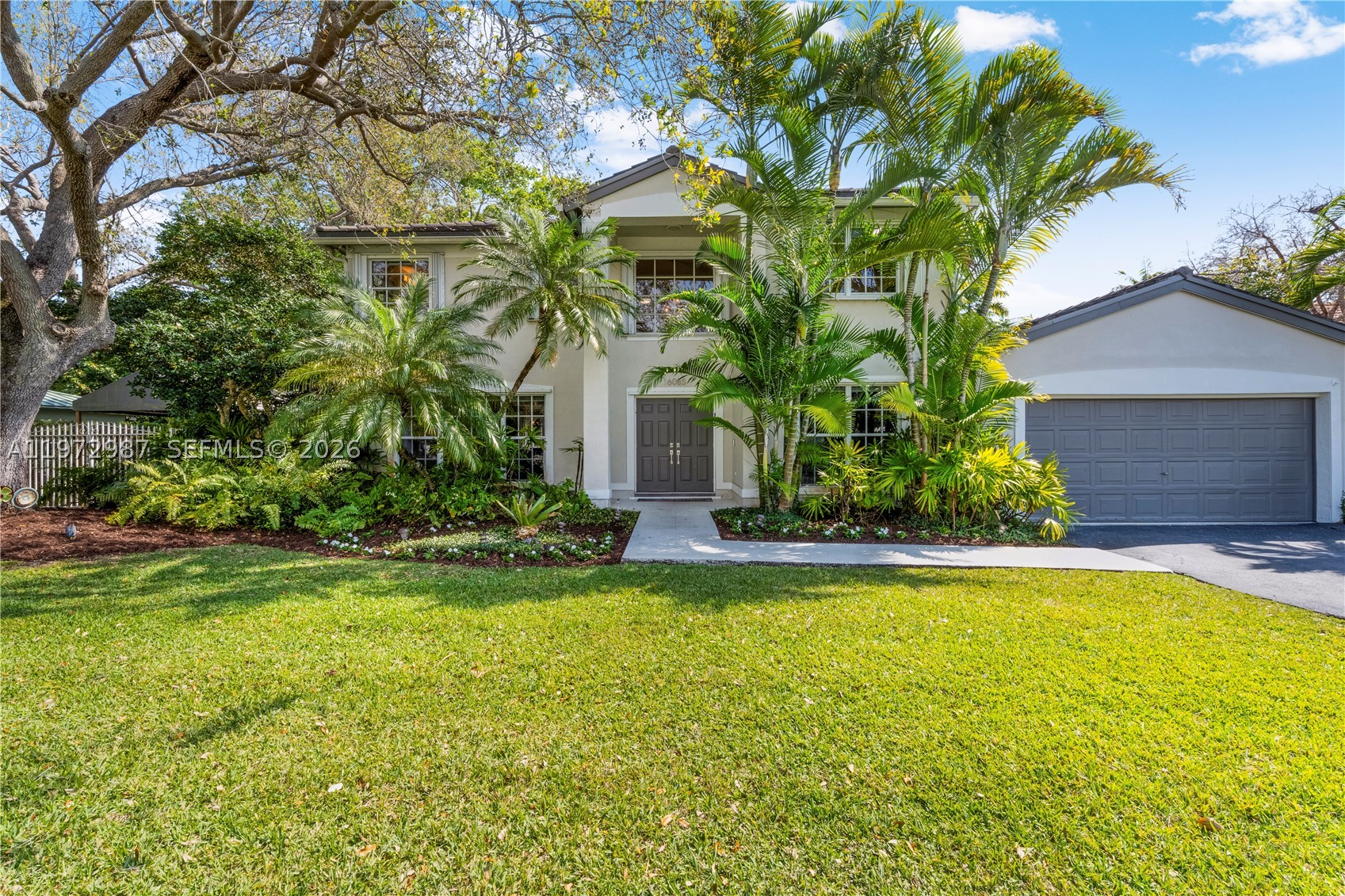 Welcome to Palmetto Bay bliss among the oak trees at Casa Roble! Tucked away on a private cul-de-sac, this beautifully updated two-story home offers the space, setting, and lifestyle you are looking for. The location is peaceful and perfect for enjoying the outdoors while remaining close to everything. Built in 1995, this 5BD/3BA residence features a functional layout with 4BD/2BA upstairs and 1BD/1BA downstairs, ideal for guests or a home office. The spacious living and dining rooms flow into an open kitchen and family room overlooking the pool and patio, creating the perfect setup for everyday living and entertaining. The eat-in kitchen features quartz countertops and ample prep space. Step outside to a private, oversized backyard shaded by magnificent oak trees. There’s plenty of room to roam, space for a boat, and a screened-in pool for indoor/outdoor Florida living year-round. Upstairs, the primary suite offers two walk-in closets and a beautifully updated bath with dual vanities, a separate shower, and a freestanding soaking tub. Additional highlights include PVC plumbing, a 10-year-old roof, two A/C units, mixed impact protection, and an EV charger. Play in the backyard and cul-de-sac, or hop on bordering paths, steps away from Coral Reef Park, Deering Estate, & top-rated public/private schools. Privacy, space, and an exceptional backyard, all in a premier cul-de-sac setting. Who is ready to call this peaceful, sought-after neighborhood and house, HOME?