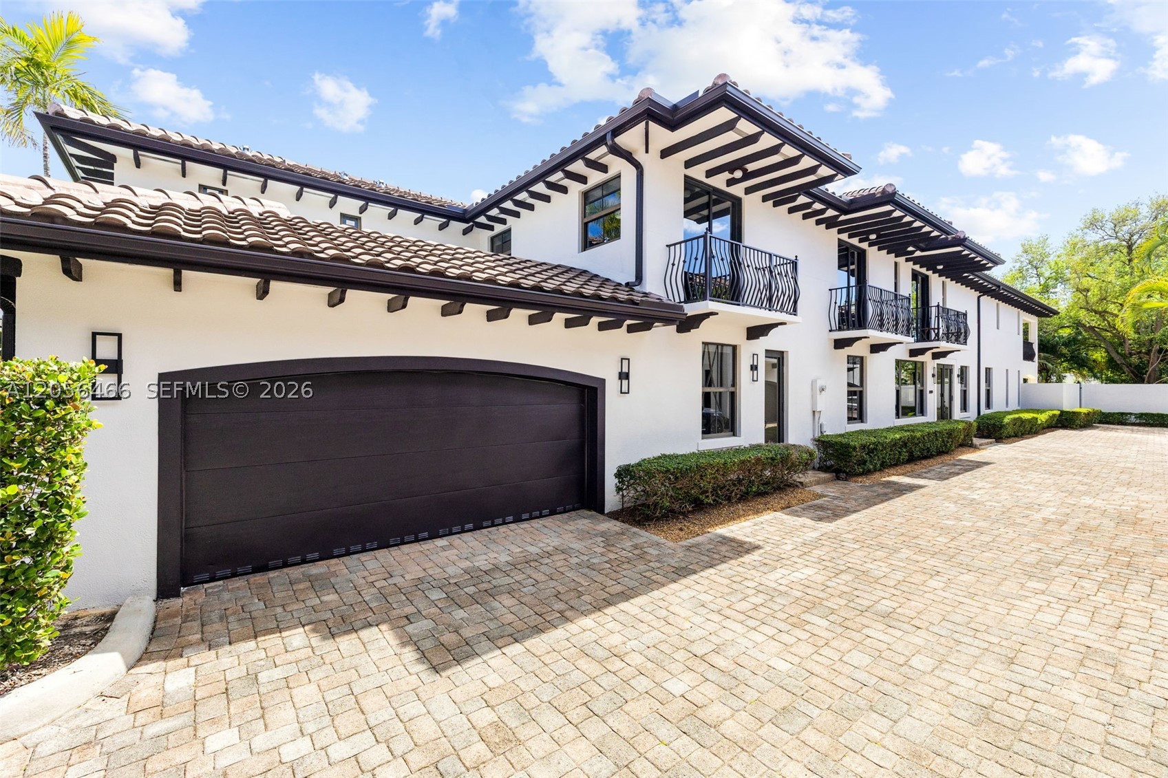 Expansive townhome in the exclusive gated community of Grove Enclave, featuring the largest floor plan with over 3,600 SF of thoughtfully designed living space. This beautifully renovated 5 bedroom, 4.5 bath residence with a den offers exceptional comfort and functionality. The spacious family room flows seamlessly into the gourmet kitchen, complete with custom cabinetry, premium finishes, and abundant storage. Each generously sized bedroom features its own ensuite bath, providing privacy and convenience. Designed for effortless indoor-outdoor living, the home boasts a summer kitchen, an expansive covered and open patio, and a private covered terrace off the primary suite. Additional highlights include a two car garage with ample storage, marble and wood flooring throughout, oversized closets, and high quality renovations to both the kitchen and bathrooms. A rare opportunity to own one of Grove Enclave's premier residences.