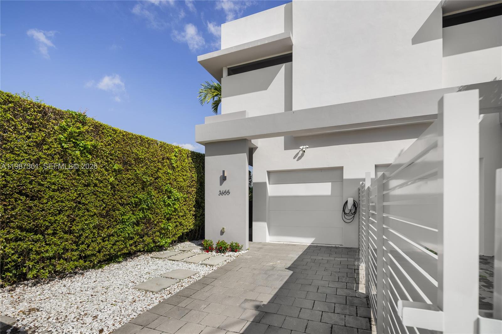 Perfectly positioned townhome in walking distance to the vibrant heart of Coral Gables. A modern residence offering a lifestyle defined by prime walkability to neighborhood parks and top tier restaurants, entertainment, and shops. Sunlight pours through impact windows and doors, illuminating an open floor plan with modern finishes and high ceilings. The indoor-outdoor flow leads to a private deck with pergola – perfect for dining, grilling, or relaxing. A generous primary suite features double sinks and double shower plus custom built-ins. Walk-in closets throughout, well-appointed laundry room, dedicated pantry, and one-car garage offer ample storage. The whole-house water filtration system, electric gate and EV charger deliver ease and peace of mind. Make this home and lifestyle yours!