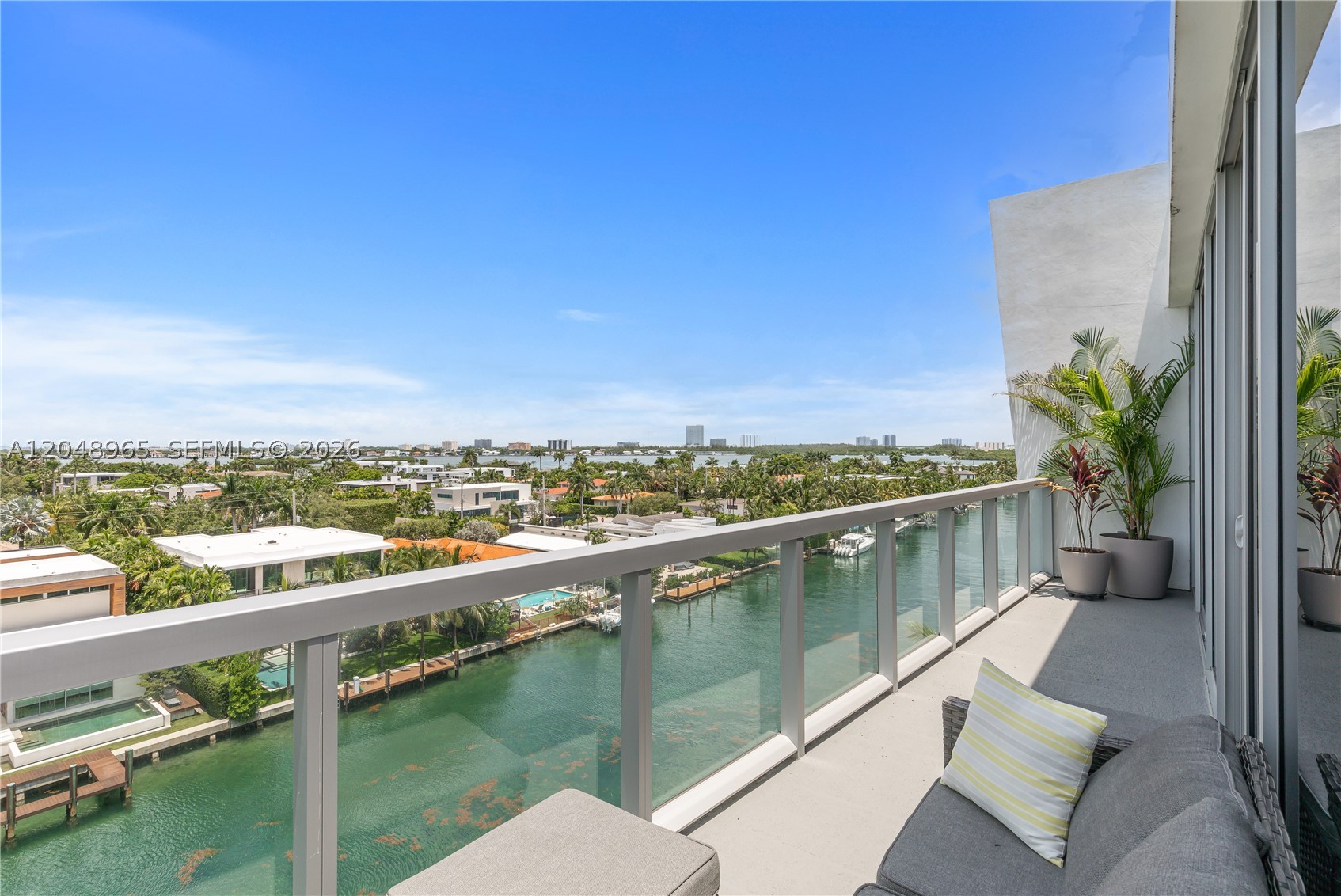 Welcome to the crown jewel of KAI — a stunning 7th-floor penthouse corner residence offering the rarest combination in Bay Harbor Islands: spectacular Southwest-facing panoramic views of Biscayne Bay, the Intracoastal, and the canal, with a boat slip available for purchase. This expansive 3-bed/3-bath residence spans 1,882 SF with an open, airy layout flooded with natural light. Beautifully appointed throughout — MiaCucina cabinetry, quartz countertops, Bosch appliances, marble baths with dual sinks, walk-in closets, impact glass, and elegant tile floors. In-unit washer/dryer. Two side-by-side assigned garage spaces. KAI is a boutique 7-story building designed by Arquitectonica featuring a rooftop infinity-edge pool, spa, BBQ terrace, fitness center, 24-hour concierge, and marina. Pet friendly. Steps to the beach, Bal Harbour Shops, top restaurants, and A+ rated Ruth K. Broad K-8 Center. Easy access to Aventura, Sunny Isles, and Miami Beach. Unfurnished and move-in ready. A rare opportunity — penthouse views, two side-by-side parking spaces, boat slip available, and turnkey luxury all in one address.
