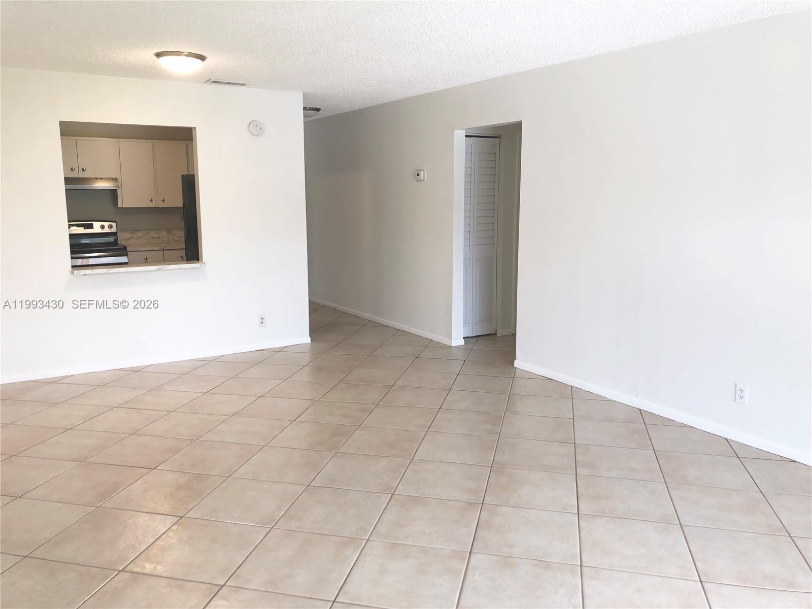 Great opportunity if you’re looking to downsize! This bright and airy unit features stainless steel appliances, updated light fixtures, a water heater, A/C, and a newer thermostat, with tile flooring throughout and vinyl in the bedrooms. Enjoy a screened-in balcony that spans the full length of the unit, along with the added convenience of an exterior storage room. The community offers a wide range of amenities with low HOA fees, including pools, tennis courts, a clubhouse, gym, and laundry facilities, plus ample parking and no age restrictions. Ideally located near schools, shopping, dining, and entertainment, with WATER included in the maintenance fee.
