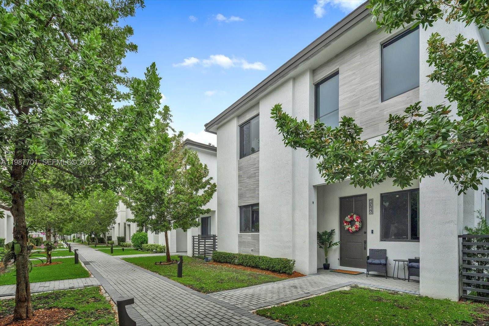 Well-maintained Tenerife model in Canarias at Downtown Doral. Built in 2022, this 4-bedroom, 3.5-bathroom home offers 2,863 sq ft with a 2-car garage. Layout features an open living area, covered terrace, front porch, and four walk-in closets. Kitchen includes upgraded cabinetry, and premium countertops. Ceramic tile floors downstairs, laminate upstairs. Primary and secondary bathrooms have been upgraded with glass shower enclosures. Smart home setup includes Google home automation, electric curtains, keypad entry, and alarm contacts. Full-size washer/dryer included. Garage has ceiling storage. Community amenities include pool, clubhouse, gym, basketball courts, covered running track, and kids' game room. Walking distance to Downtown Doral shops, restaurants, and Charter Schools. Easy access to Publix and Baptist Urgent Care.