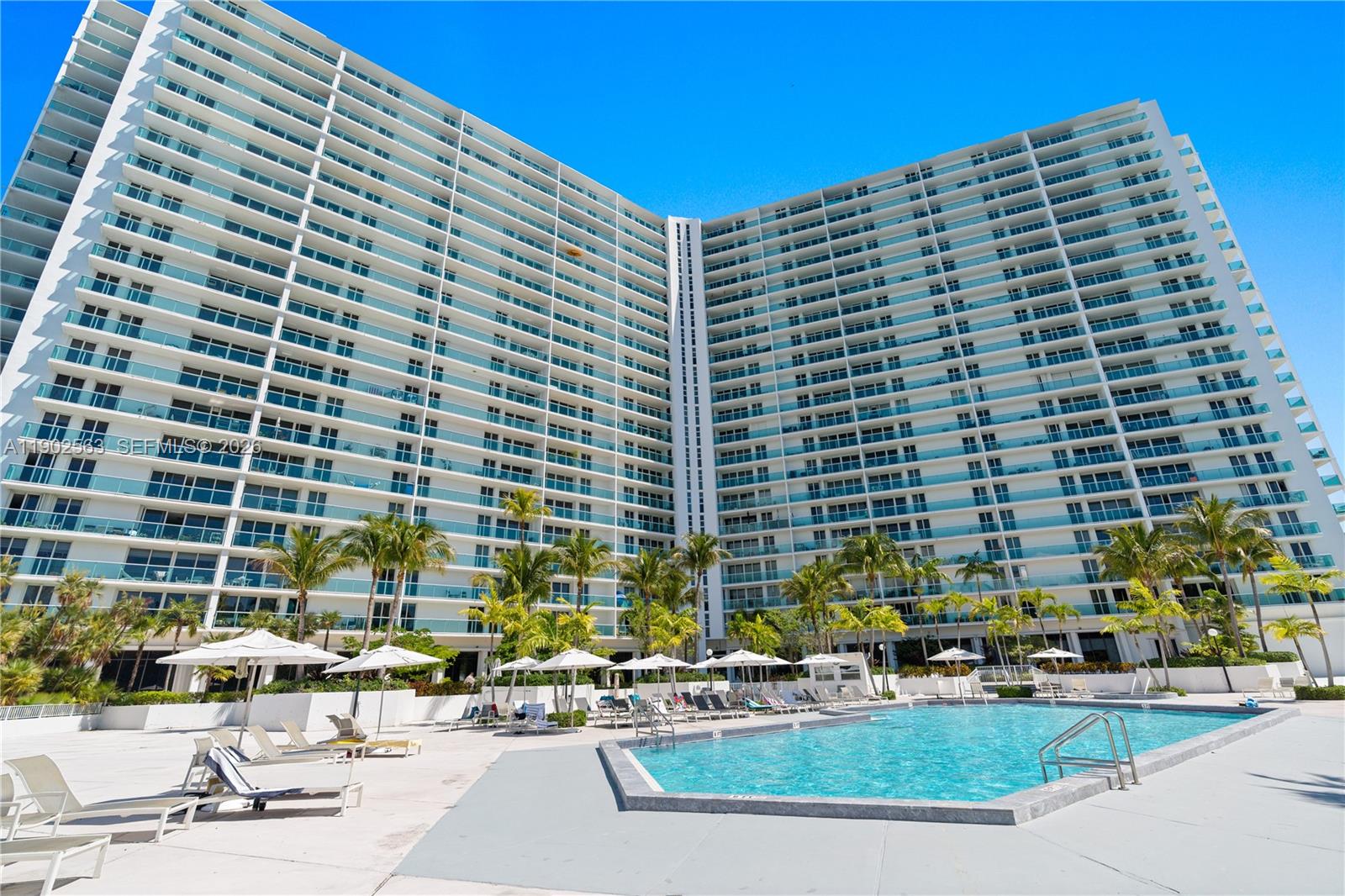 Newly remodeled 2-bed/2-bath residence in Sunny Isles Beach featuring elegant wood finishes, light-filled living areas and a refined open, split-bedroom layout. Fresh kitchen and baths with premium materials and contemporary lines. Enjoy sweeping sunset views over the Intracoastal and watch boats glide by from a large private balcony. Resort-style amenities include tennis courts, pool, gym, spa, on-site restaurant and convenience store. Direct beach access across the street, access to docks (in case you like boats), 24/7 security and valet parking. Prime location near Bal Harbour, Oleta River Park and Aventura Mall. Move-in ready.
