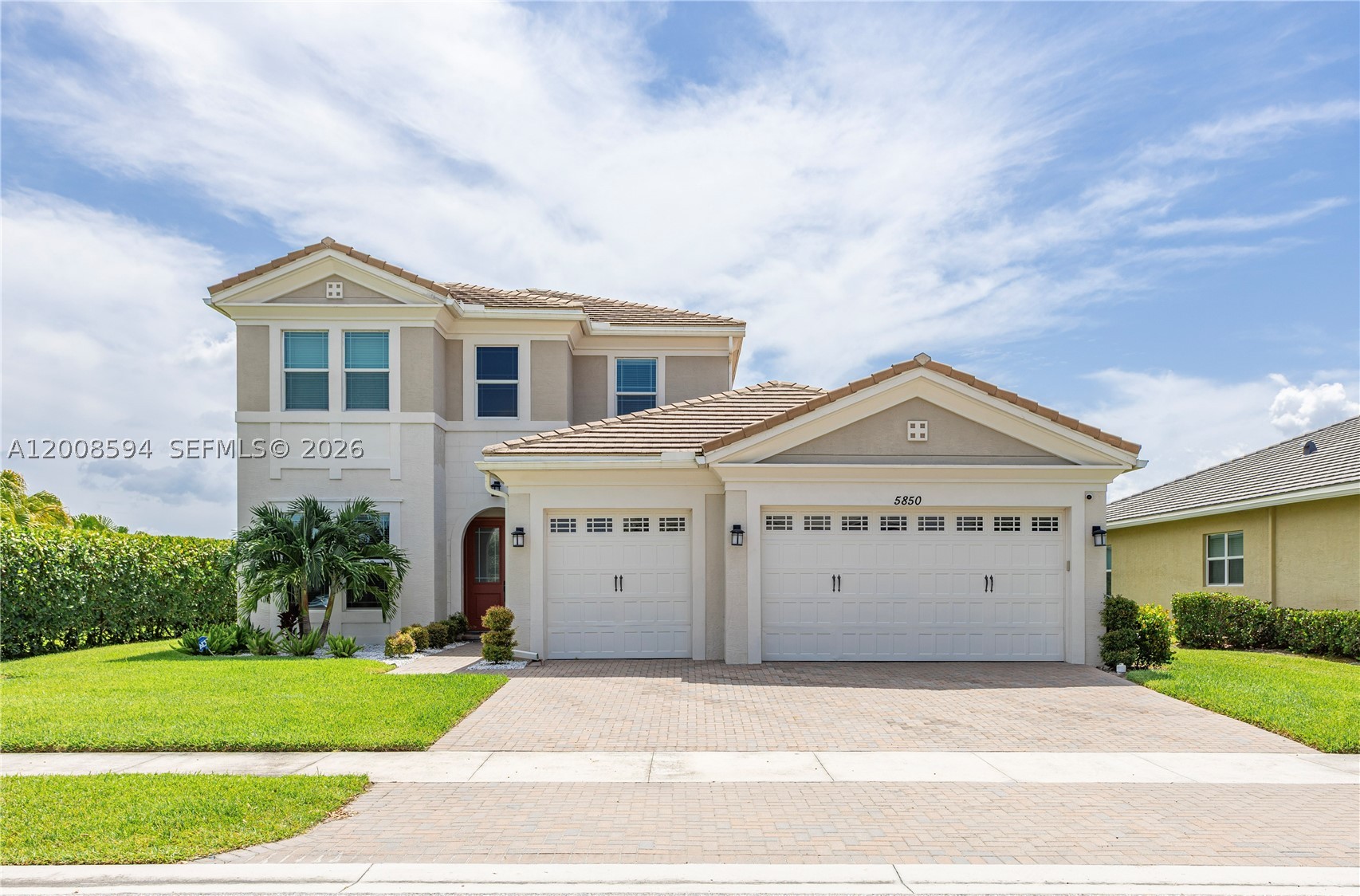 Welcome to this exceptional waterfront residence in the highly sought-after Hammocks at Westlake. Offering over 4,000 sq. ft. under A/C, this beautifully designed home features 6 bedrooms, 5 full bathrooms, and a 4-car garage. Premium upgrades include impact windows, an EV charging station, and numerous designer finishes throughout.

The open-concept floor plan is ideal for both everyday living and entertaining. The chef's kitchen features contemporary cabinetry, stone countertops, stainless steel appliances, a large center island, and abundant storage while overlooking the spacious living and dining areas with tranquil water views.

The expansive primary suite offers a generous walk-in closet and a spa-inspired bathroom with dual vanities and a walk-in shower. Five additional bedrooms provide flexibility for guests, a home office, fitness room, or multigenerational living.

Relax on the covered lanai overlooking the water or enjoy the private backyard with plenty of space for outdoor entertaining. Residents of Westlake enjoy resort-style amenities including a lagoon pool, splash park, Adventure Playground, BMX pump park, basketball courts, dog park, event lawn, and scenic walking and biking trails. Conveniently located near shopping, dining, major highways, Palm Beach International Airport, and South Florida beaches.