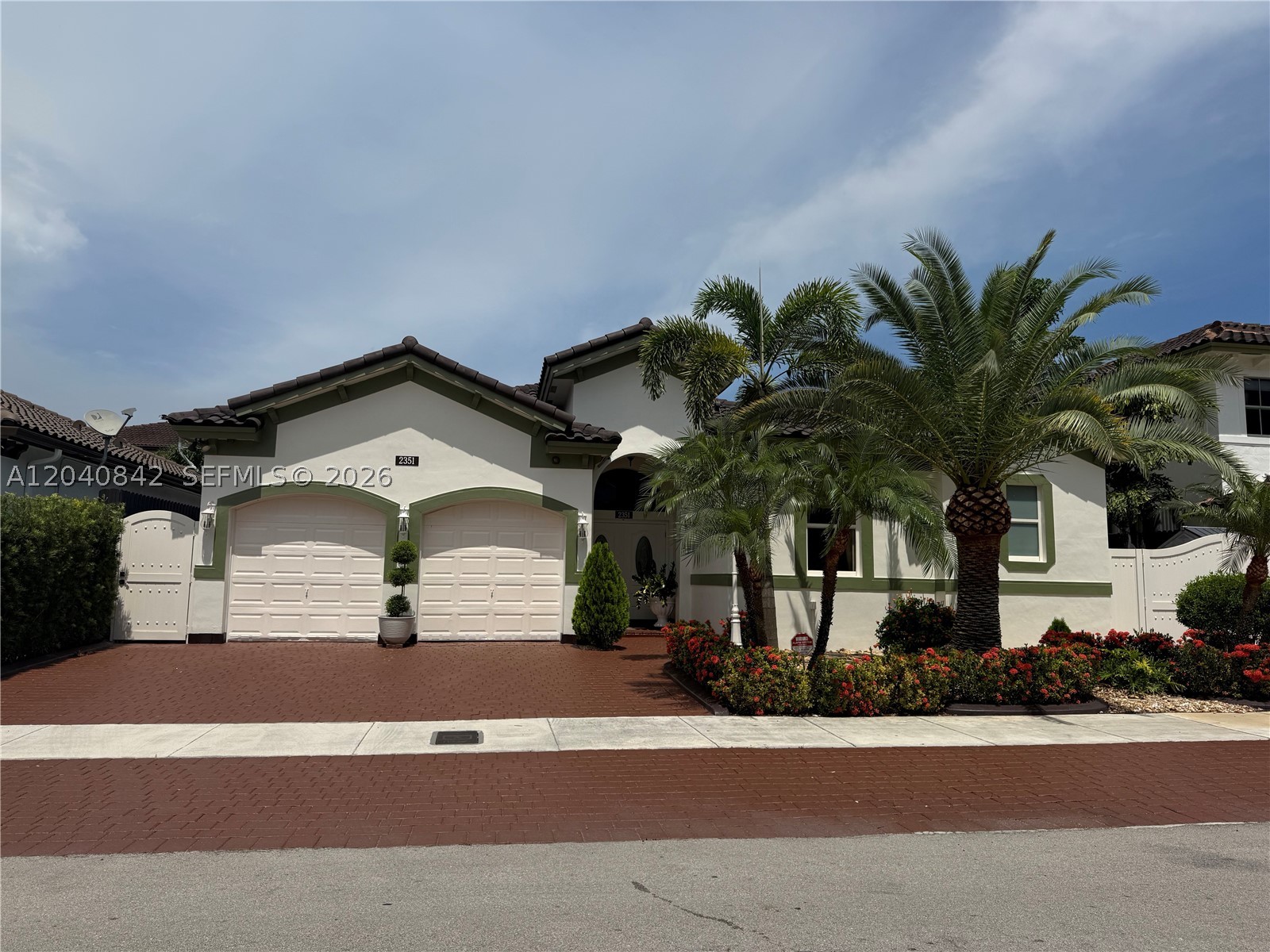 Situated on a generous 6,744 s/f lot in a quiet, family-oriented neighborhood with NO HOA! Offering 2,686 total s/f, this meticulously maintained residence features 3 bedrooms, 2.5 bathrooms, and a spacious 2-car garage. Open floor plan, high ceilings, elegant crown molding, beautiful crystal chandeliers throughout, and stunning 24" x 24" porcelain flooring installed throughout. Additional upgrades include impact-resistant windows and doors, central vacuum system, double insulation in the roof and walls for enhanced comfort and energy efficiency, insulated garage door, sprinkler system, California closets, and thirteen security cameras installed around the property. Exterior windows, metal gates, and garage doors have been professionally finished with durable electrostatic paint. The remodeled kitchen features custom wood cabinetry, granite countertops and backsplash, brand-new stainless-steel appliances, and ample storage and workspace. The oversized primary suite measures approximately 24' x 19' and serves as a private retreat, complete with a wall-mounted air-conditioning unit, two spacious closets measuring approximately 7' x 5' each, and a luxurious classic-style bathroom featuring a Jacuzzi tub, oversized shower, separate toilet, and bidet. Step outside to enjoy the beautifully landscaped backyard, designed for relaxation and entertaining including a brand-new fence, a custom-built 16' x 13' pergola constructed with sturdy 6" x 6" posts and interior lighting.