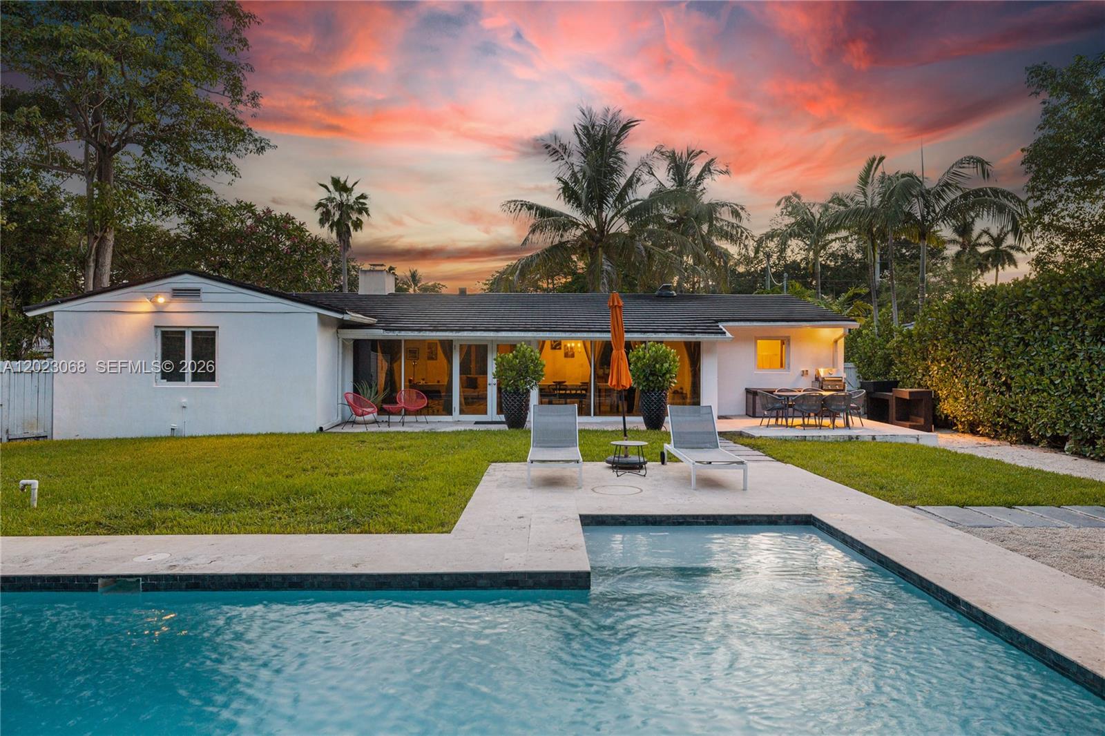 Tropical Dream Villa in Miami with Pool Beautifully updated, turn-key Biscayne Park pool home located on a
peaceful, tree-lined street. This spacious 3-bedroom, 3-bathroom home features a large family room and formal
dining area, all overlooking a serene backyard oasis. The modern kitchen is equipped with stainless steel
appliances, granite countertops, and a wine cooler—perfect for entertaining. Relax in the private, fenced backyard
with a sparkling pool, covered seating area, and lush landscaping. The large front yard offers ample parking. Enjoy
close proximity to shops, restaurants, parks, and more—just 15 minutes from the Design District and Bal Harbour
Shops.