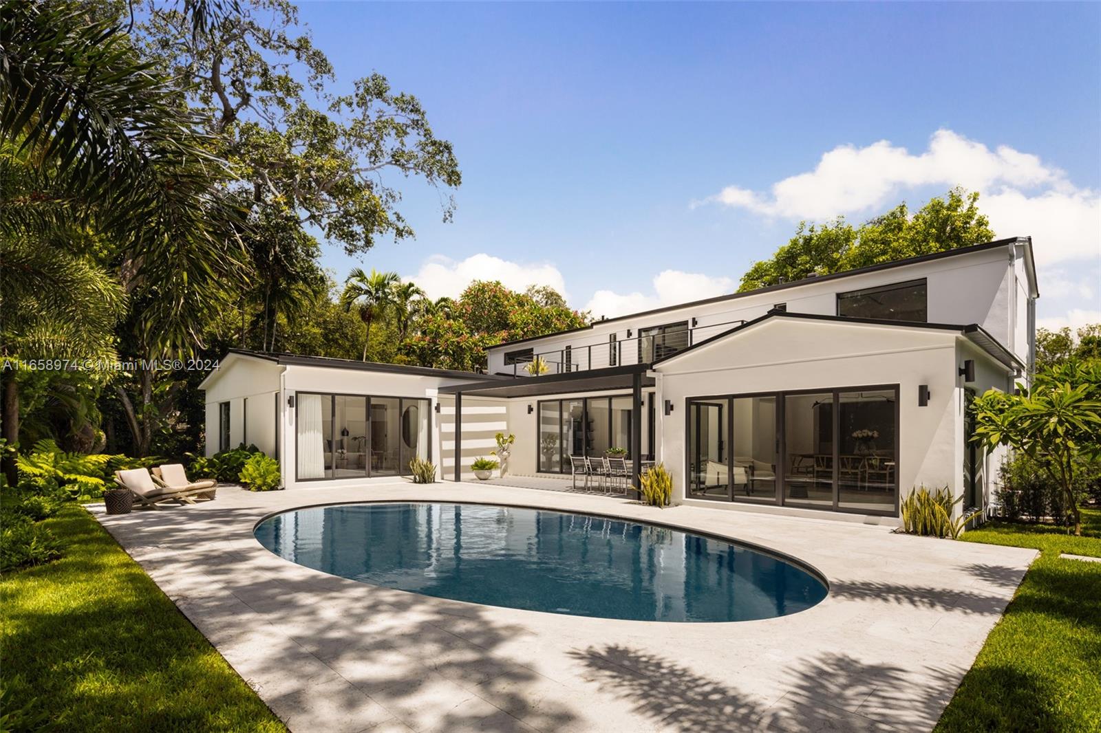 Newly completed and expertly designed 4,228 SF gated residence with 5-bedrooms and 5.5-bathrooms, on a generous 10,700 SF lot in a highly sought-after North Grove neighborhood. The open, airy floor plan is filled with natural light,  showcases beautiful hardwood floors throughout, and offers interiors crafted by the renowned Farache Bromberg Design Studio. A gourmet kitchen boasts sleek custom cabinetry, Neolith Travertine countertops, high-end Miele appliances, and a dedicated dining space. Perfectly suited for entertaining, the beautifully landscaped backyard includes an oval-shaped pool, limestone deck, and trellis. Other features include impact windows and doors, exquisite millwork, oversized terrace, fireplace, and garage.
