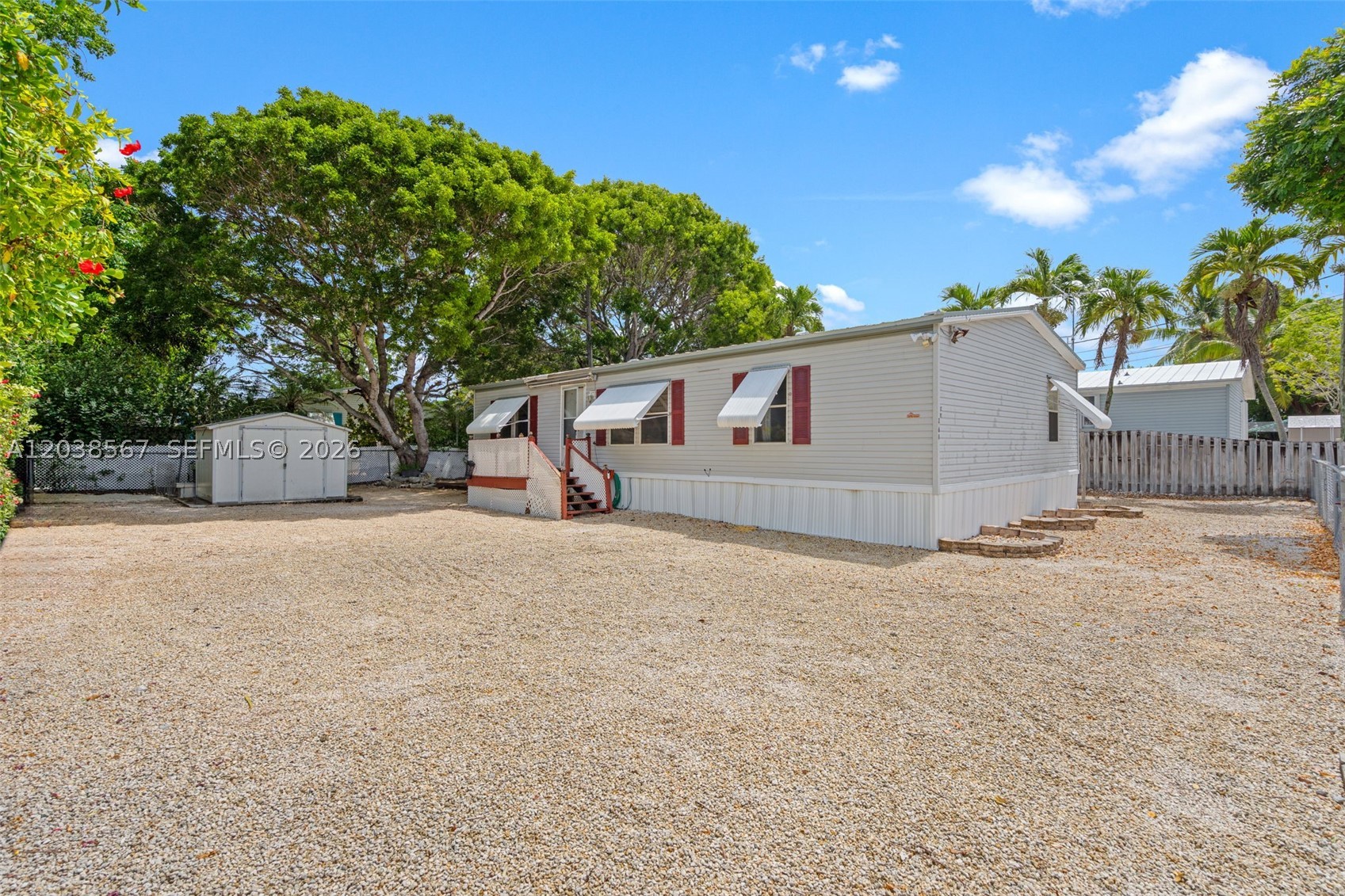 Welcome to this Key Largo property--ideal as a primary residence, vacation getaway, or short-term rental (28-day minimum). This double-wide manufactured home features a spacious floor plan with three bedrooms, two bathrooms, ample closet and storage space throughout, and a utility room for the washer and dryer. The property includes stainless steel appliances, a front-loading washer and dryer, a newer metal roof, a newer central air conditioner, and a newer water heater. Set on a fenced, 6,000 sq. ft. lot, it easily accommodates a large boat, an RV, or both. Joining the Homeowners' Association is optional. If opted in, this is a $125.00-per-year fee that includes access to the boat ramp. Just one block away, residents have exclusive access to a private boat ramp--making it effortless to enjoy endless adventures on the water.
