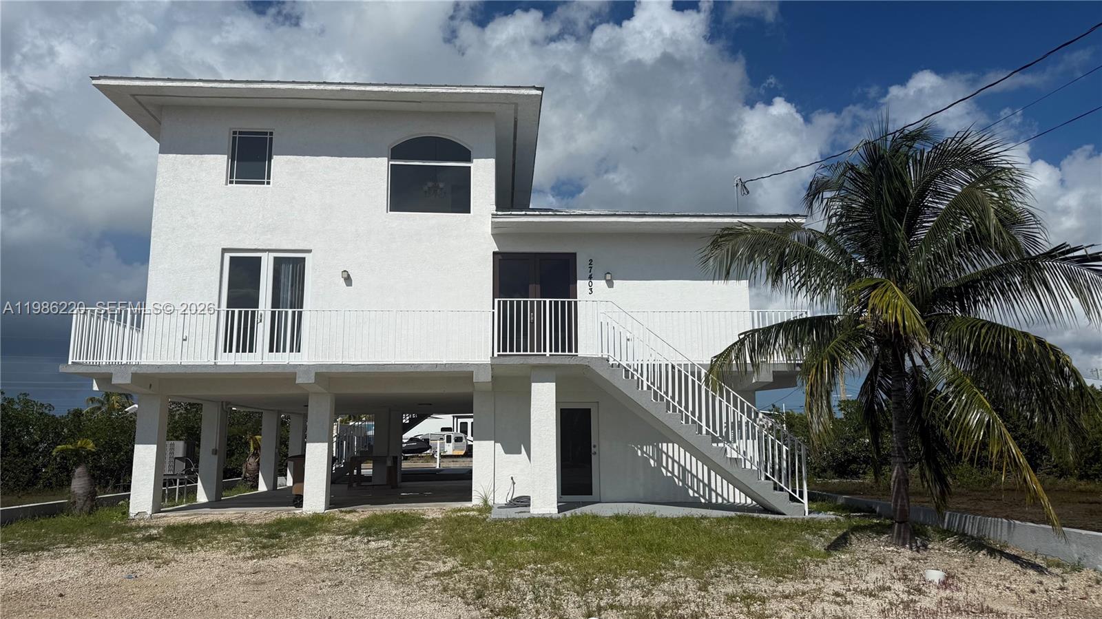 Waterfront value-add opportunity in the Florida Keys with direct ocean access and no fixed bridges - perfect for serious boaters with vessels up to 60 feet. 
Situated on an oversize 18,000 SF lot, this property offers rare space, flexibility and future potential not commonly found in the Keys. The elevated concrete home features a spacious layout, multiple balconies, and abundant natural light throughout. With kitchen and bathrooms ready for renovation, this is the perfect canvas to create a custom waterfront residence or maximize value through a strategic upgrade.
Enjoy ample outdoor space with room for expansion, a pool, additional storage or enhanced landscaping - making this property uniquely versatile for both end-users and investors.
Ideally located within close proximity to Key West, offering convenient access to world class dining, entertainment and boating, while still enjoying the privacy and tranquility of canal front living.